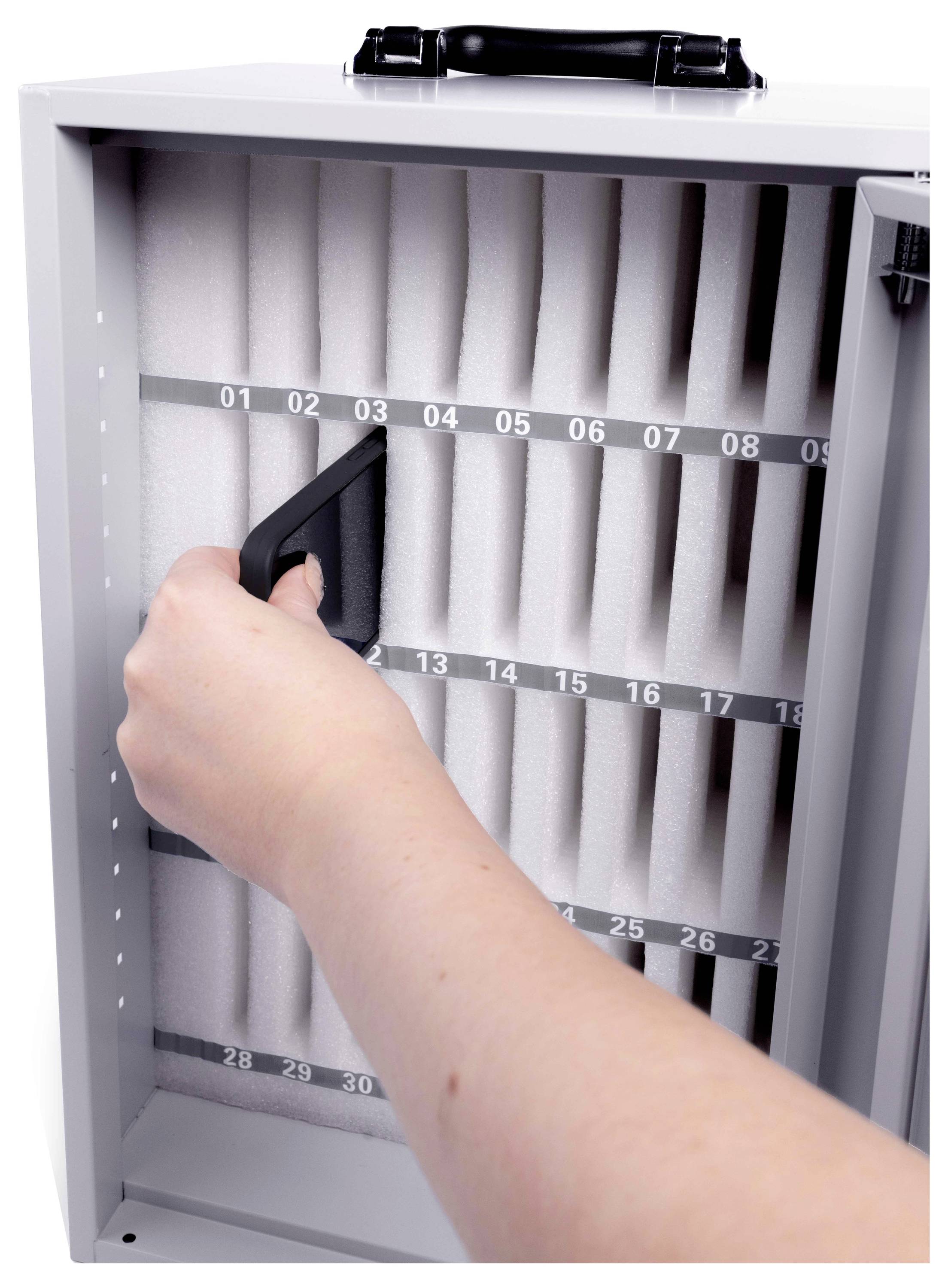 Hand öffnet einen gefalteten Luftfilter in einer wandmontierten HVAC-Filtereinfassung und zeigt nummerierte Schlitze im Filterrahmen.