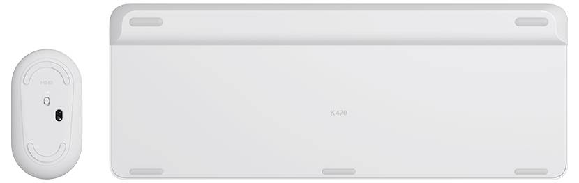 Weiße kabellose Maus neben einer schlanken weißen Laptop- oder Tablet-Basis, von hinten fotografiert.