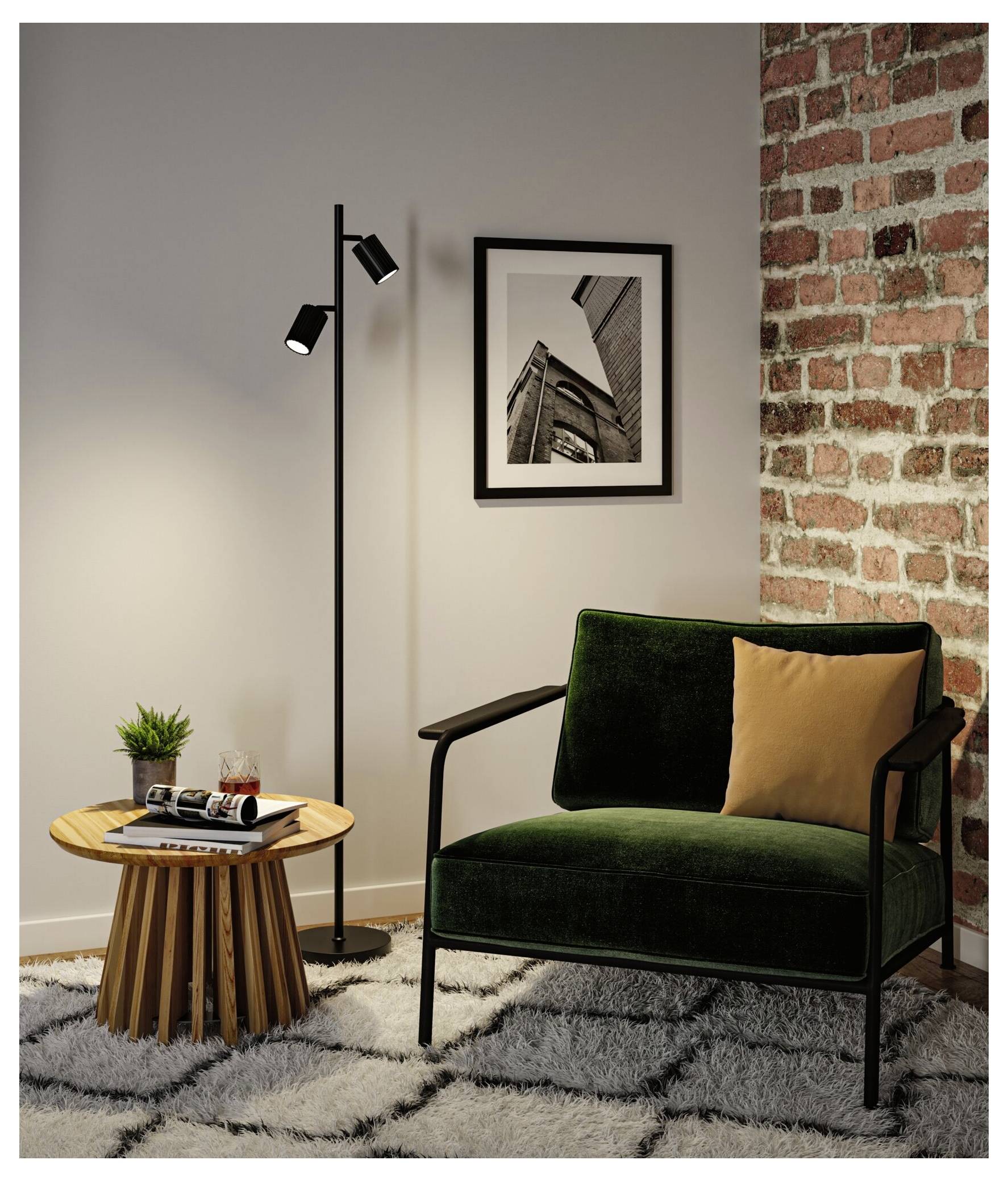 Moderne Wohnzimmerecke mit grünem Sessel, Stehlampe, Beistelltisch, eingerahmtem Wandkunstwerk und freiliegender Backsteinakzentwand.