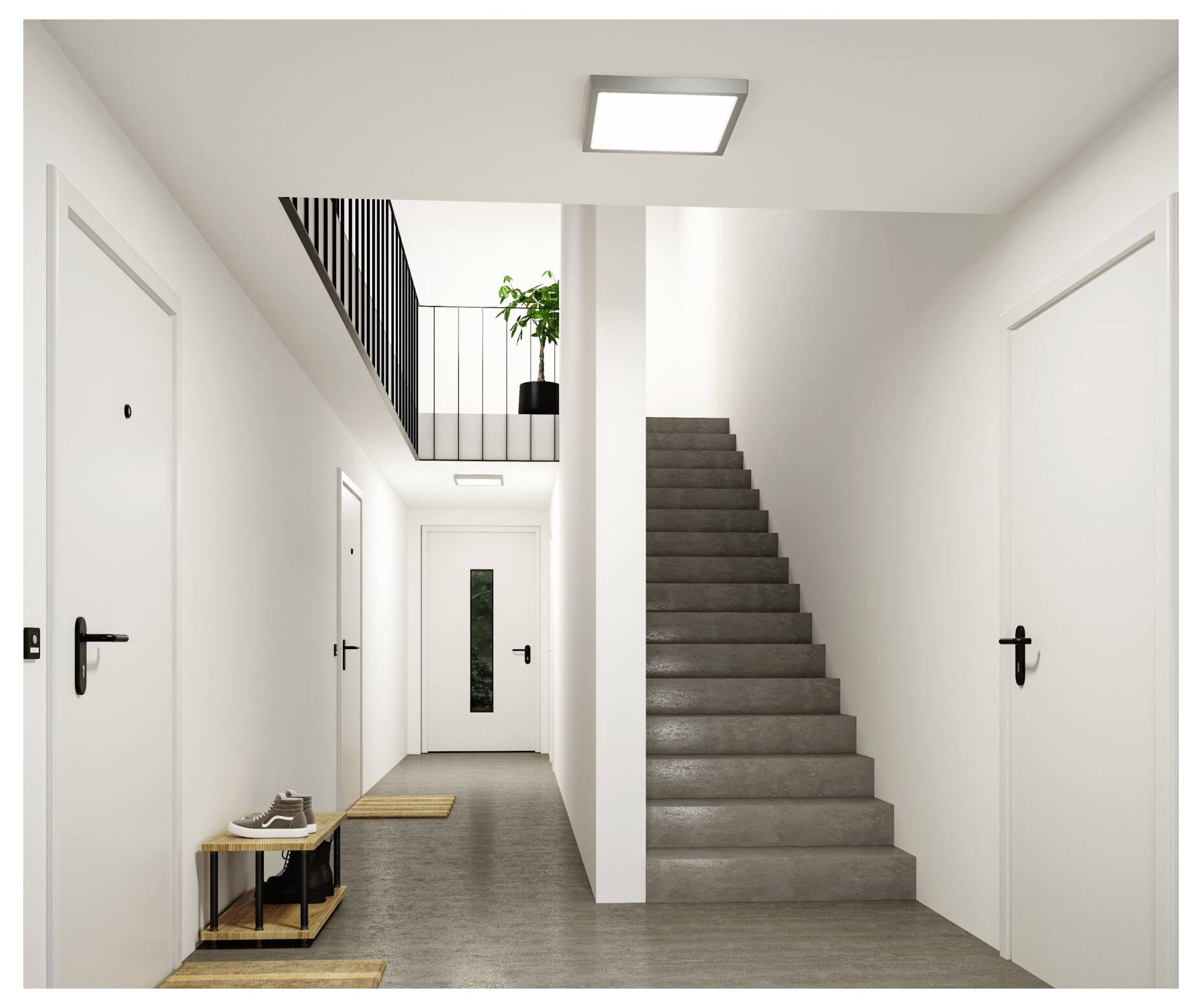 Moderner Flurbereich einer Wohnung mit grauer Treppe, weißen Türen, Oberlicht und einer kleinen Schuhbank in der Nähe des Eingangs.