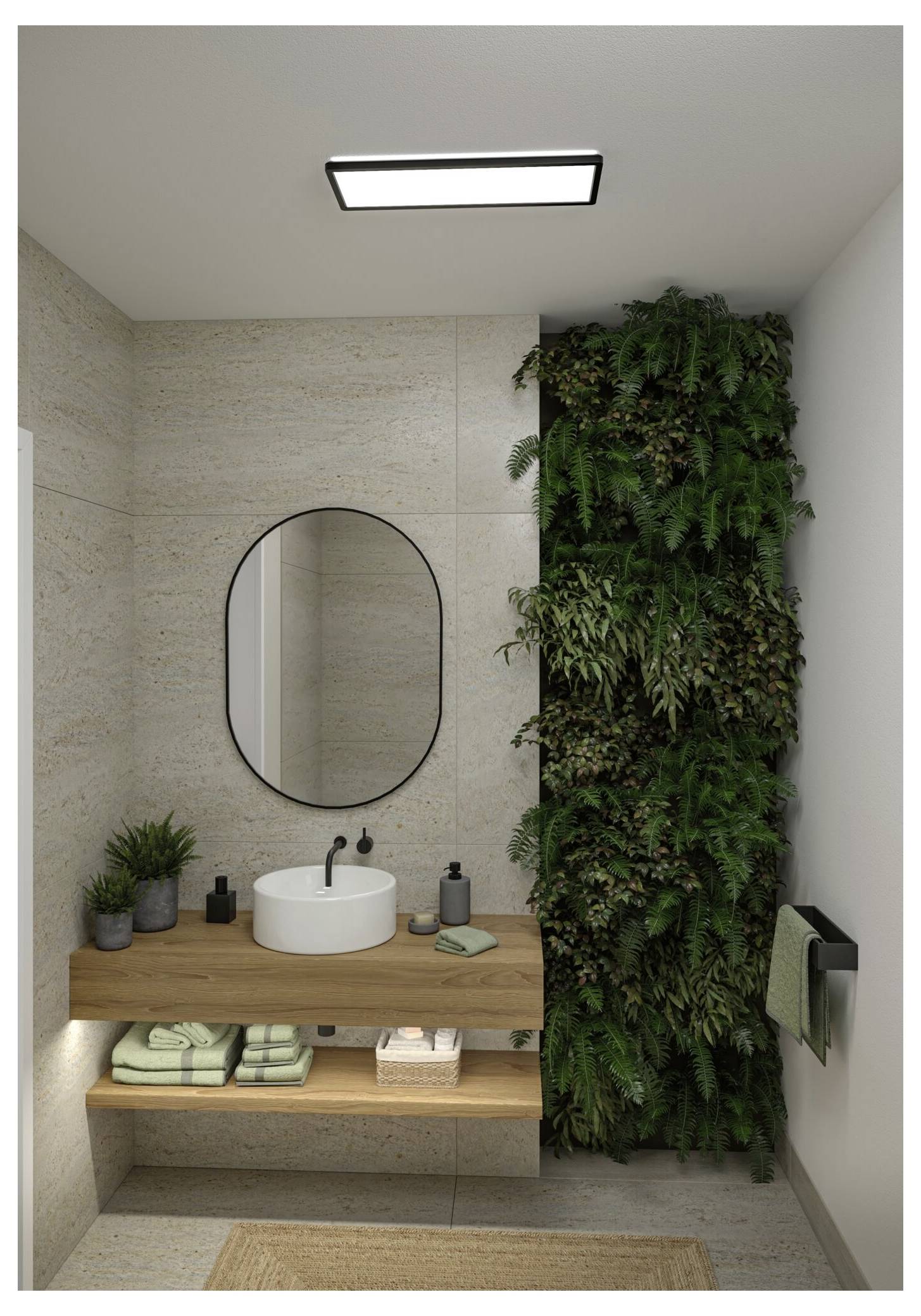 Modernes Badezimmer mit schwebendem Holzwaschbecken, ovalem Spiegel, weißem Waschbecken und einer üppigen vertikalen Pflanzenwand neben dem Waschbecken.