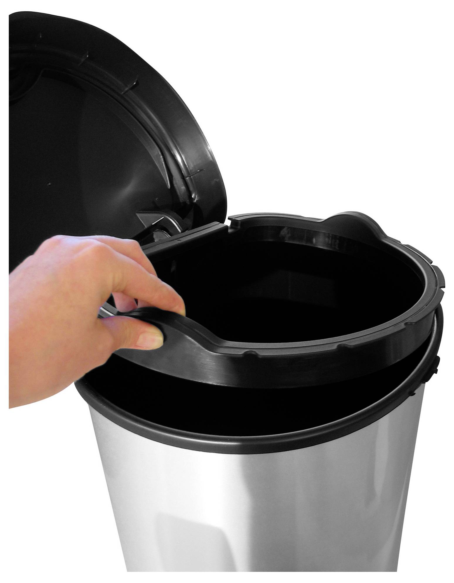 Hand platziert einen Müllbeutel in einen offenen Edelstahl-Treteimer mit angehobenem Deckel.