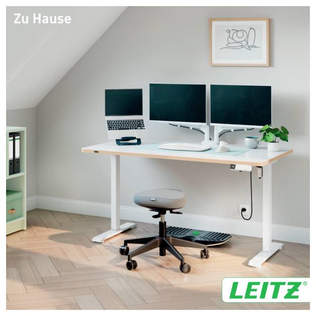 Homeoffice mit verstellbarem Schreibtisch, Dual-Monitoren, Laptop, Hocker, Tastatur und Pflanze unter gerahmter Wandkunst; 