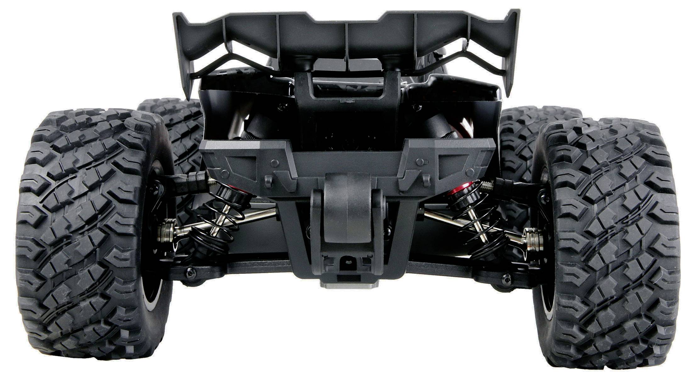 Vorderansicht eines Gelände-RC-Auto-Fahrgestells mit großen Profilreifen, freiliegender Federung und ohne Karosserie auf weißem Hintergrund.