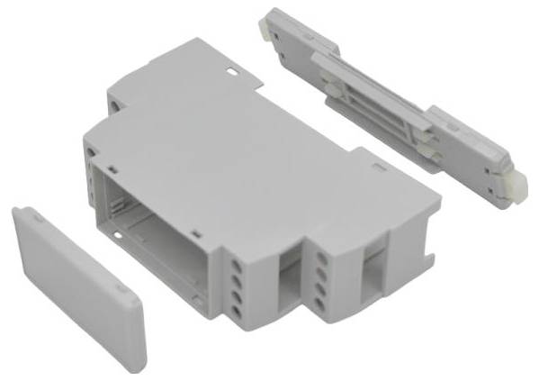 Graues modulares Elektrosteckergehäuse mit zwei abgenommenen Seitenkappen auf weißem Hintergrund.