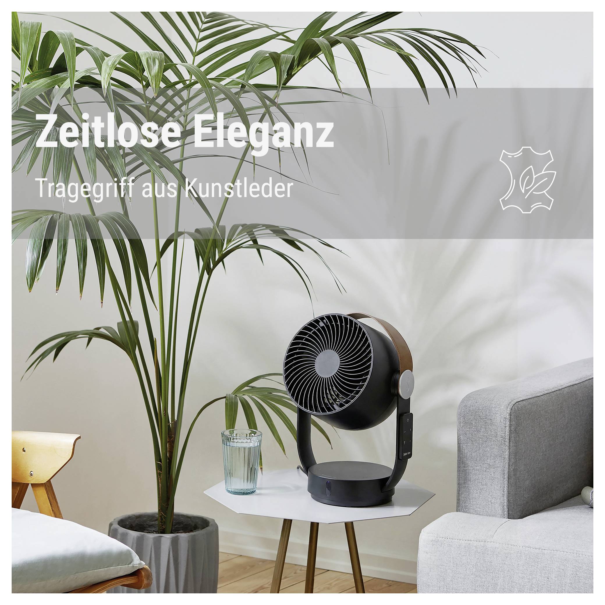 Luftreiniger mit Kunstledergriff neben einer Zimmerpflanze im Wohnraum; Text: 'Zeitlose Eleganz' und 'Tragegriff aus Kunstleder'.