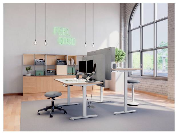 Moderner Büroarbeitsplatz mit Stehpulten, Monitoren, Hockern, Regalen, großen Bogenfenstern und Neon-Schild mit der Aufschrift „FEEL GOOD