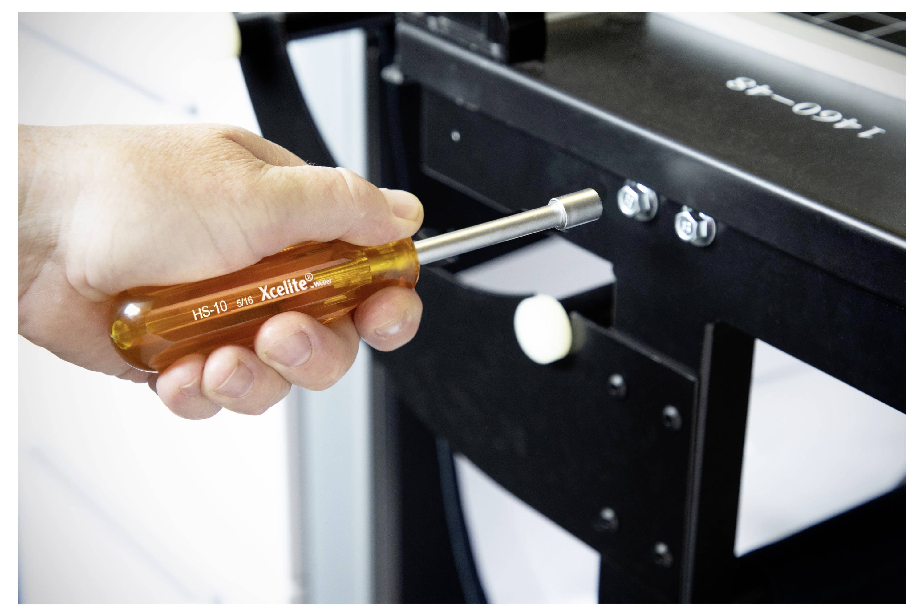 Hand mit einem Schraubendreher zur Reparatur des Inneren eines Computer-Towers mit freiliegenden Kabeln und Komponenten.