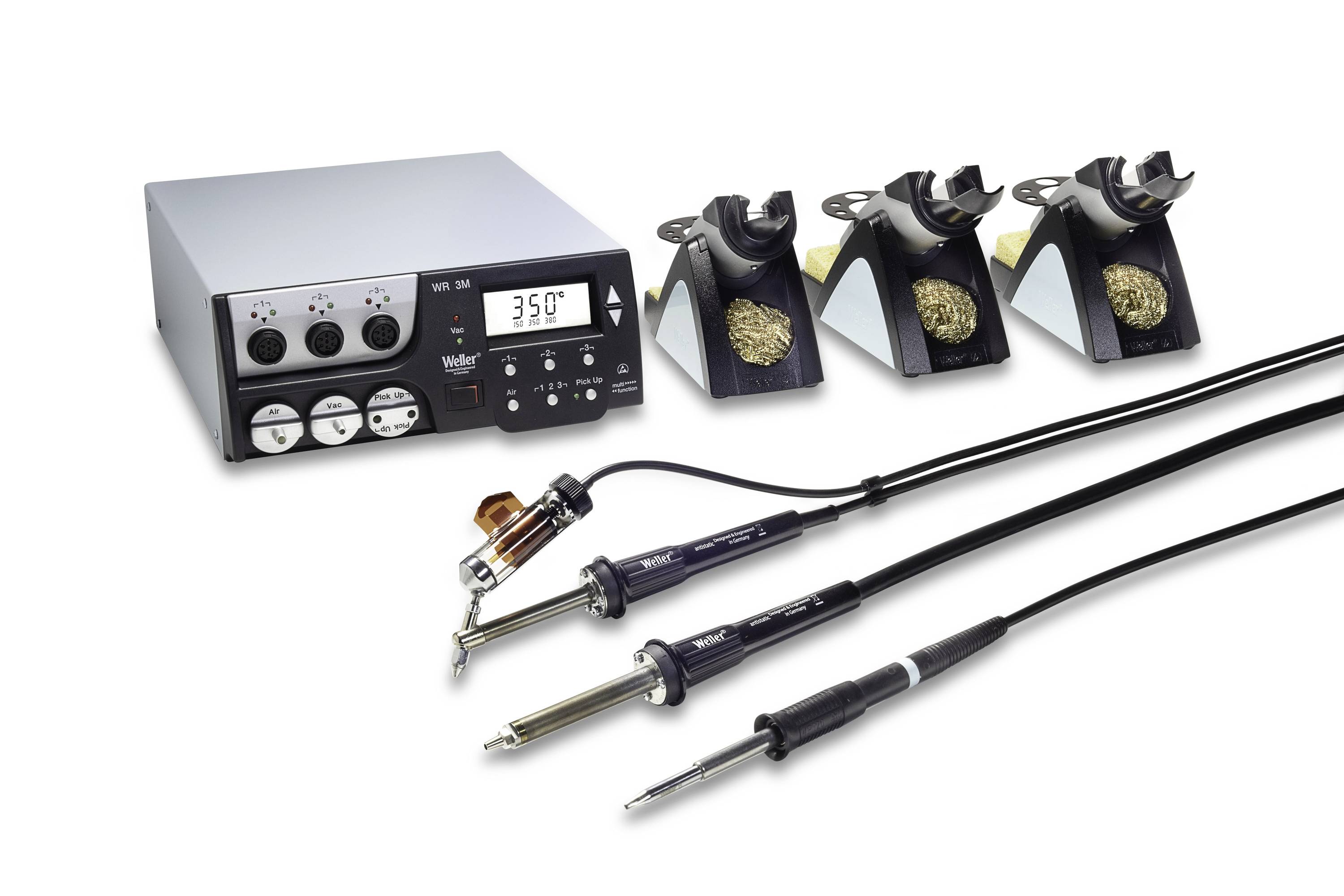 Soldering station with digital temperature display and three iron holders with brass wool, plus three soldering irons with cords.