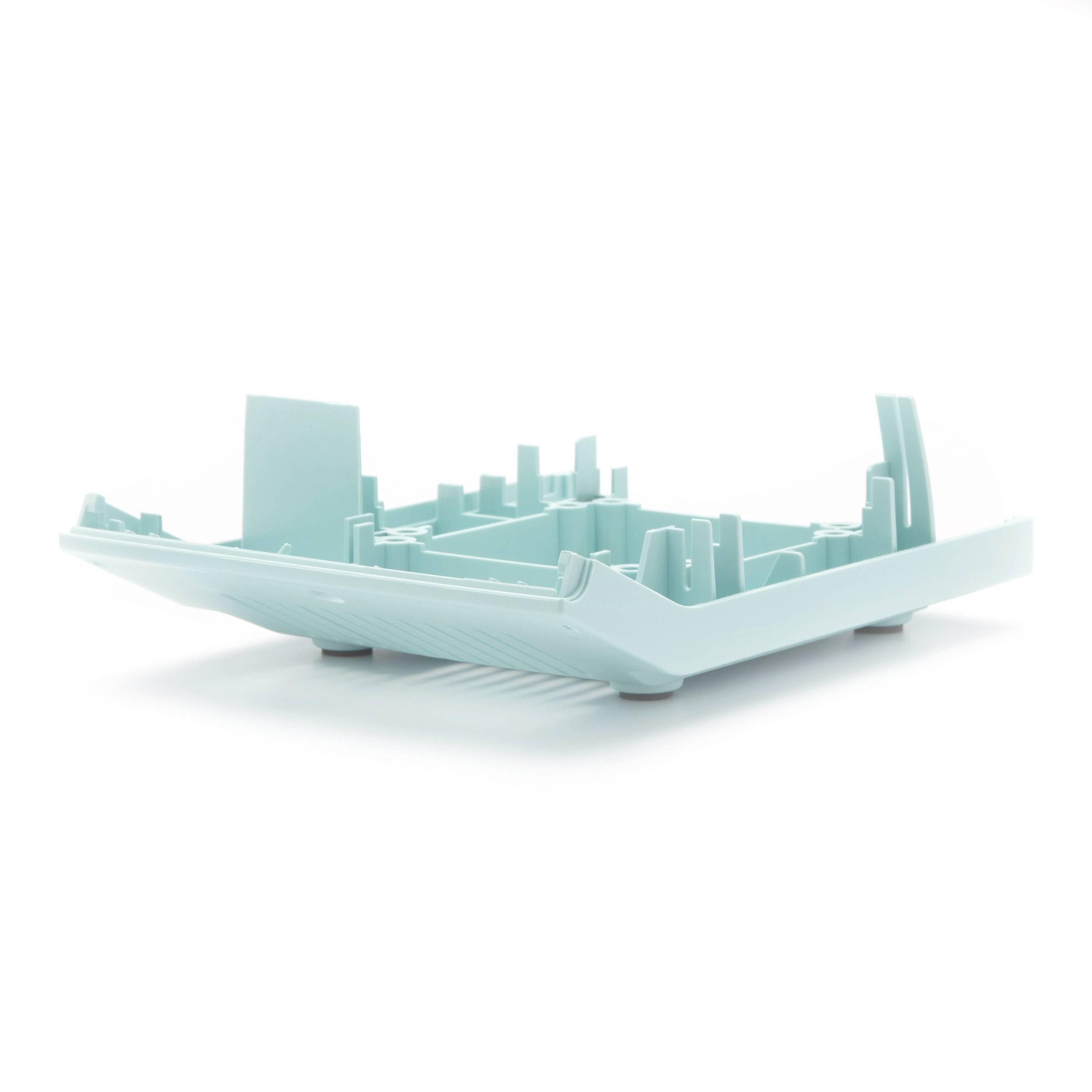 3D rendered teal city skyline model in a shallow tray, shown on a white background.