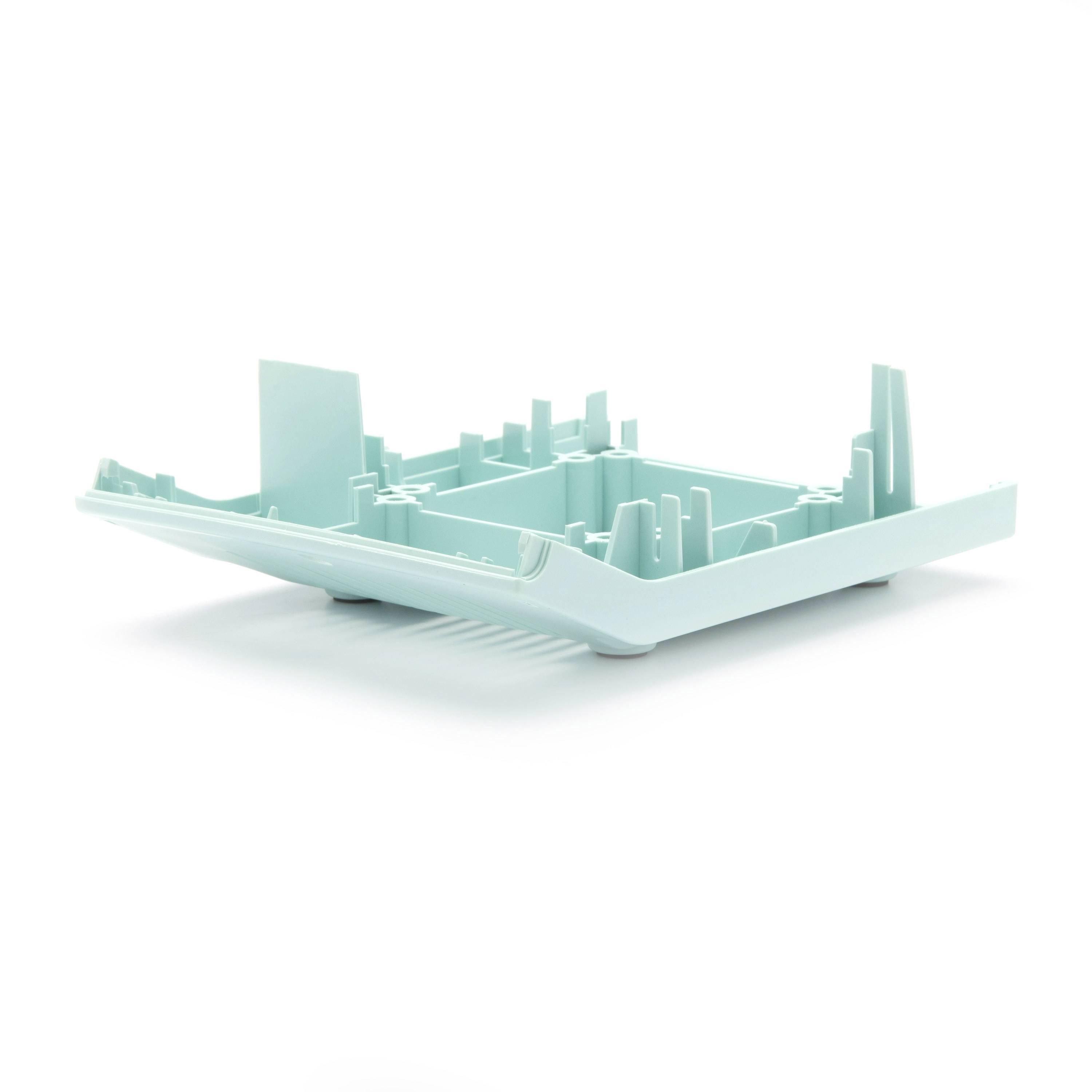 Mint-green 3D model of a city on a shallow tray, with buildings rising from a rectangular platform on a white background.