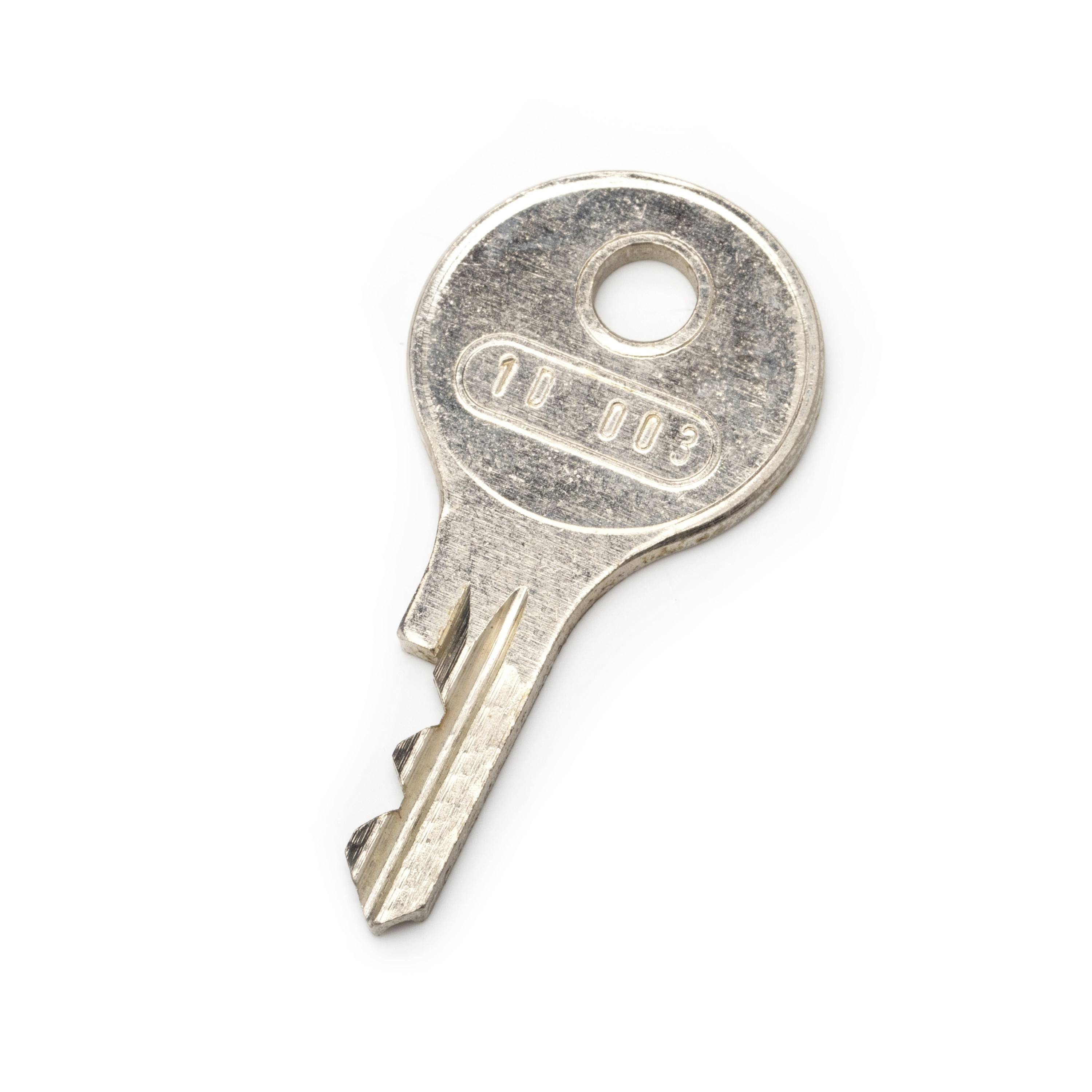 Close-up of a silver metal key on a white background, viewed from above.