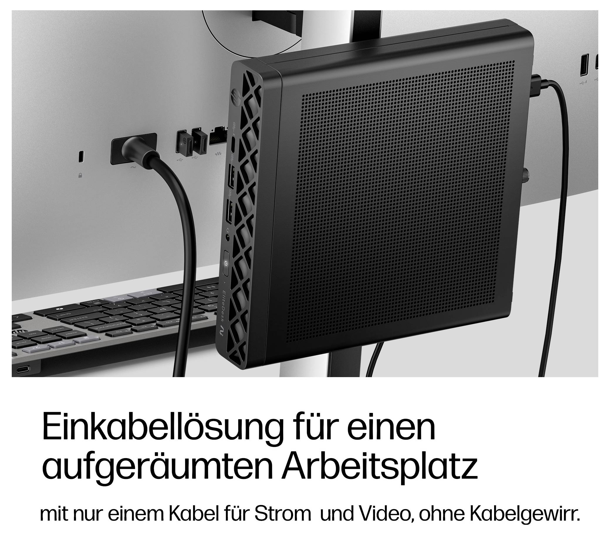 Kompaktcomputer hinter einem Monitor montiert, mit einem Kabel für Strom und Video; deutscher Text besagt „Single-Cable-Lösung für einen aufgeräumten Arbeitsplatz