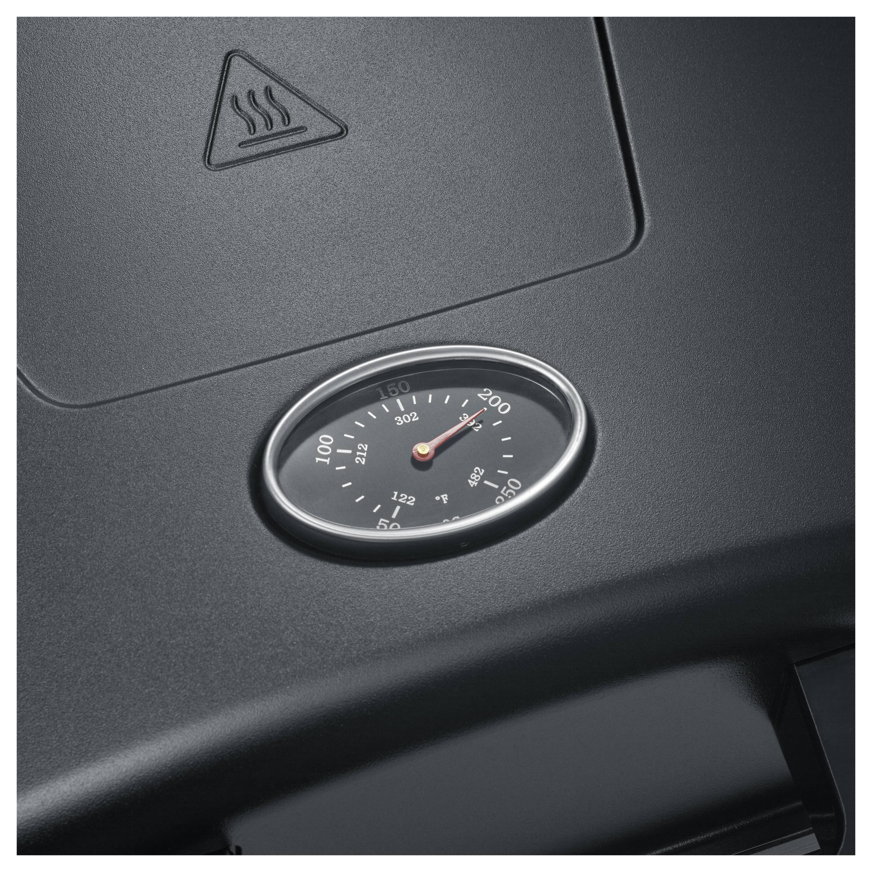 Nahaufnahme eines autoarmaturenbrett-ähnlichen Thermometers mit einer in Grad gekennzeichneten Skala, wobei sich die Nadel nahe bei 200 befindet und ein Wärmewarn-Symbol darüber angezeigt wird.