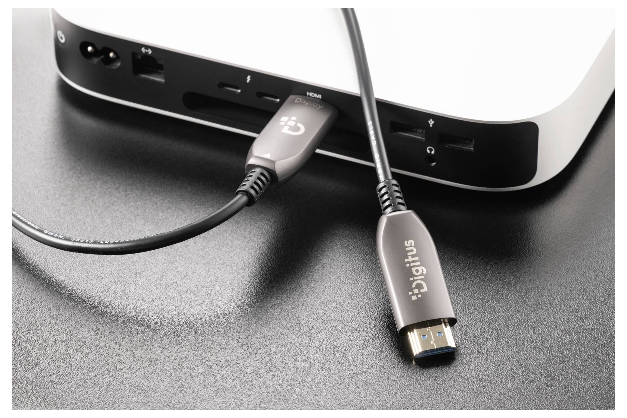 Zwei USB-Kabel, die in die vorderen Anschlüsse eines weißen Geräts eingesteckt sind, zeigen seine verbundenen Anschlüsse und Verbindungen.