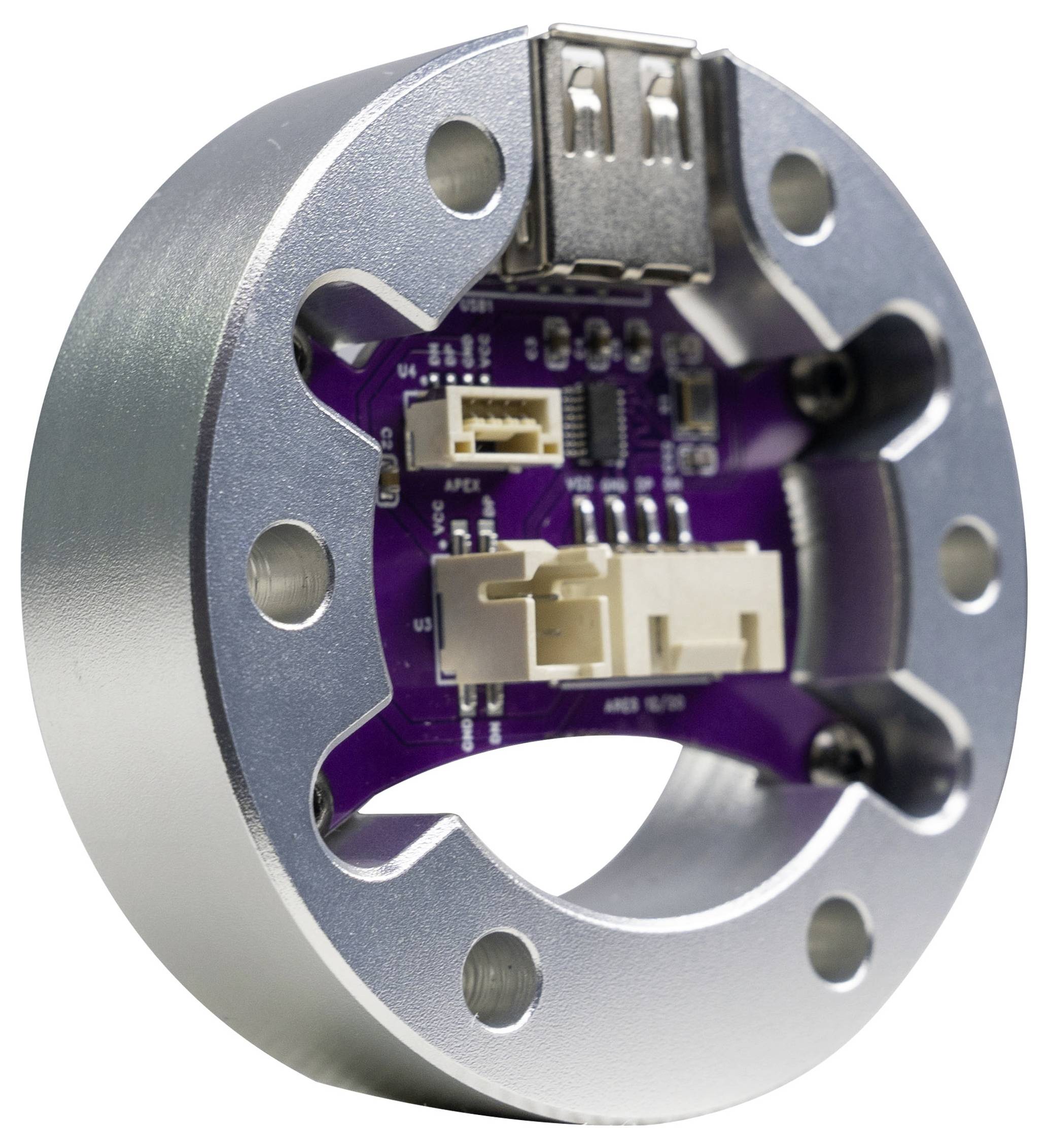 Nahaufnahme eines kreisförmigen Metallgehäuses eines elektronischen Geräts mit einer violetten Leiterplatte und Anschlüssen im Inneren, dargestellt vor einem weißen Hintergrund.