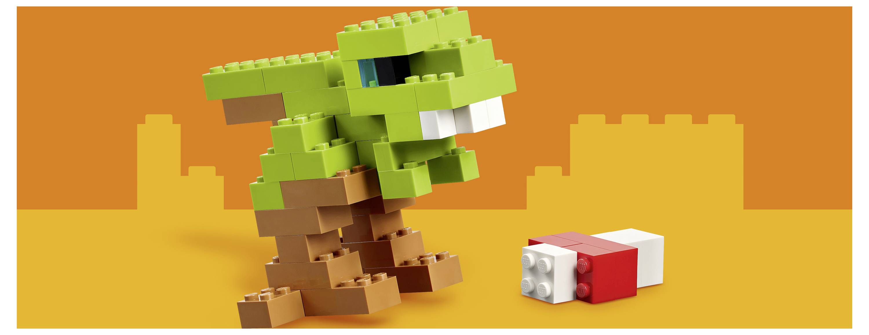 Ein grüner LEGO-ähnlicher Dinosaurier steht über einem kleinen rot-weißen Block auf orangefarbenem Hintergrund.