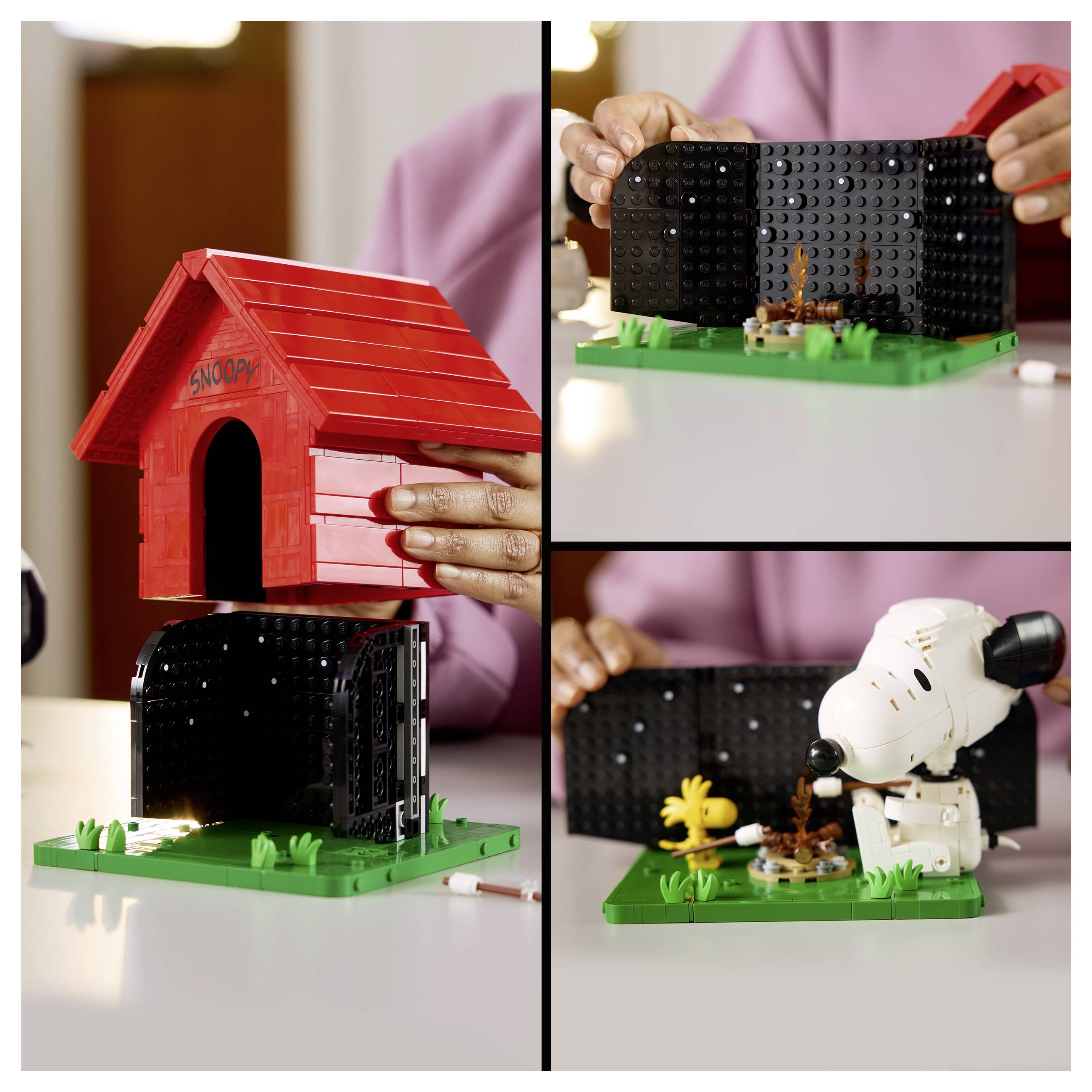 Person, die ein LEGO-Snoopy-Hundehütten-Set zusammenbaut, zeigt das rote Dach, die schwarze Basis und die Snoopy-Figur auf einer grünen Grundplatte.