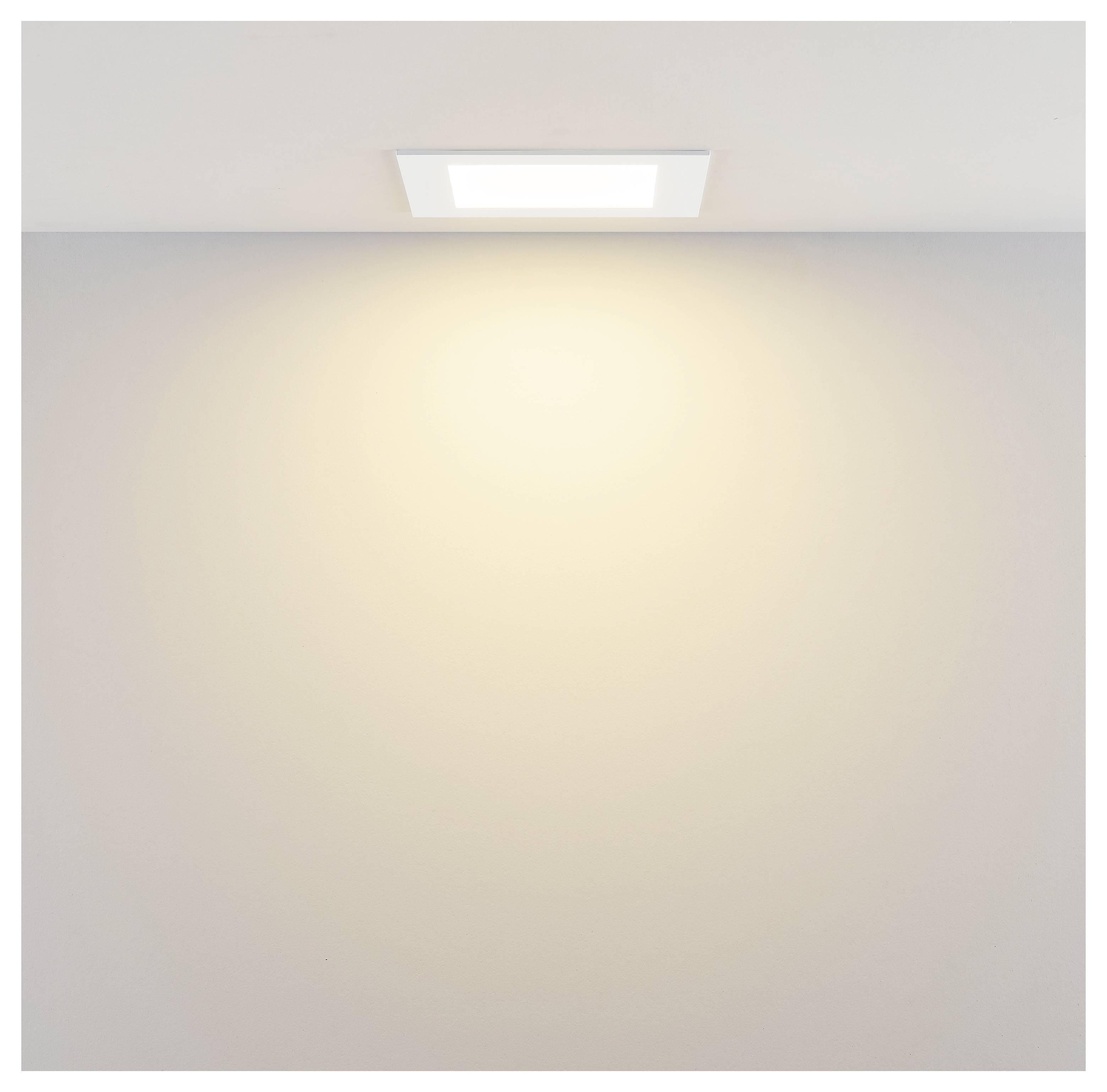 Einbaudeckenleuchte, die ein warmes Licht auf eine schlichte Wand und Decke ausstrahlt.