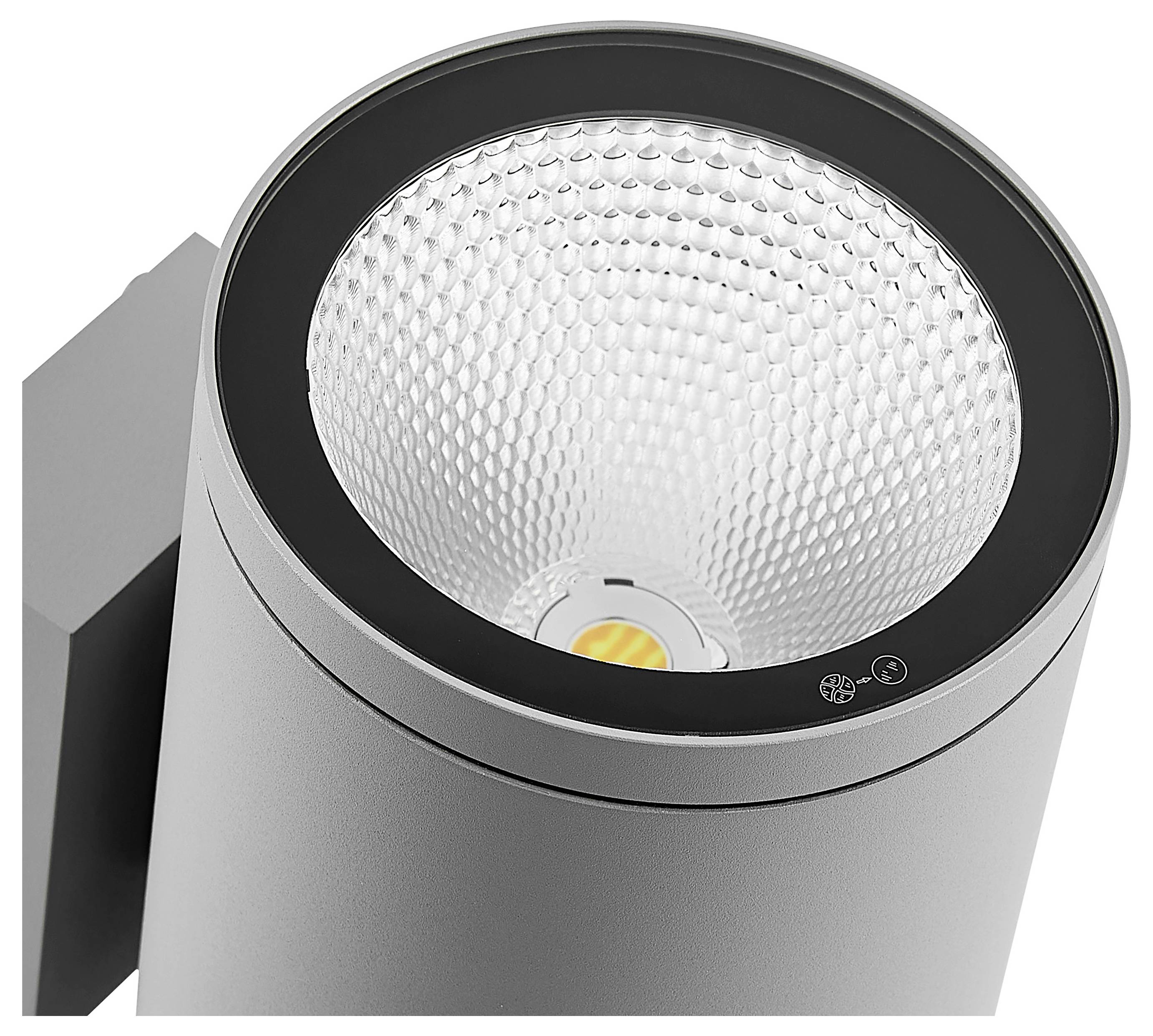 Nahaufnahme eines modernen zylindrischen Schwarz-Silber-Scheinwerfers mit strukturiertem Reflektor und sichtbarer LED-Lichtquelle.