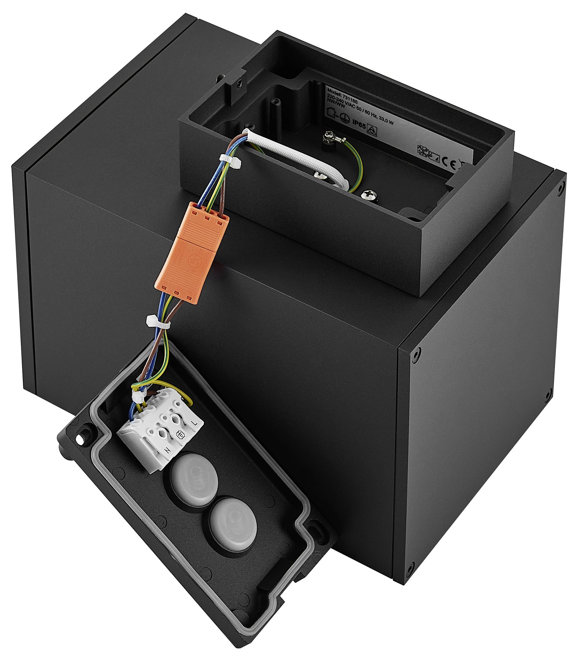 Schwarzes Elektrogehäuse, geöffnet dargestellt, mit sichtbarer innerer Verdrahtung, Anschlussklemmen und einem aufklappbaren unteren Fach mit zwei runden grauen Komponenten.