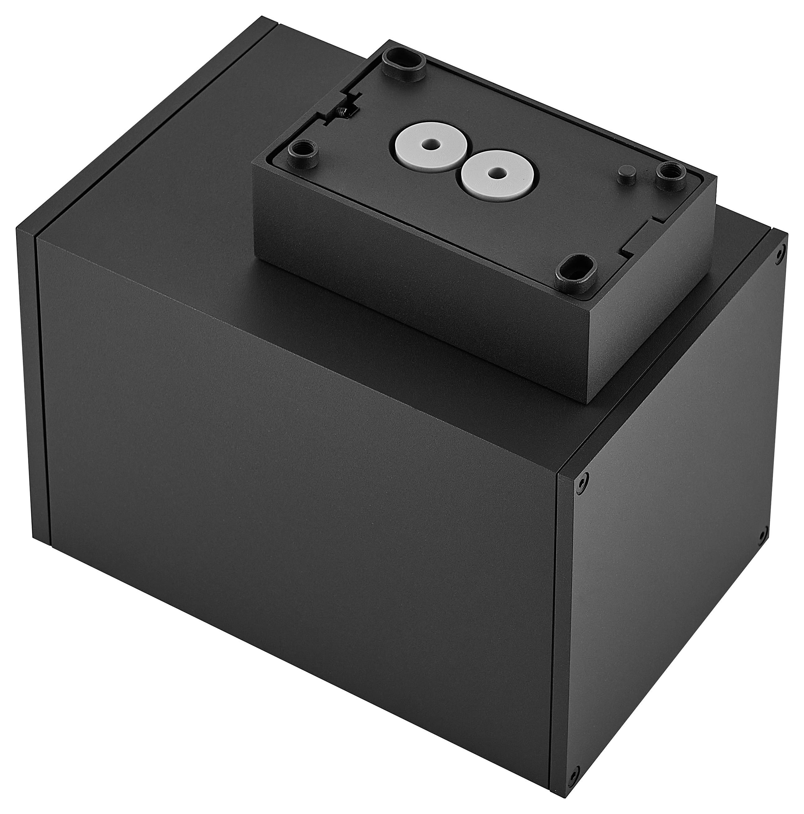 Schwarzes rechteckiges elektronisches Gehäuse mit einem kleineren Topmodul, das zwei kreisförmige Anschlüsse oder Stecker aufweist.