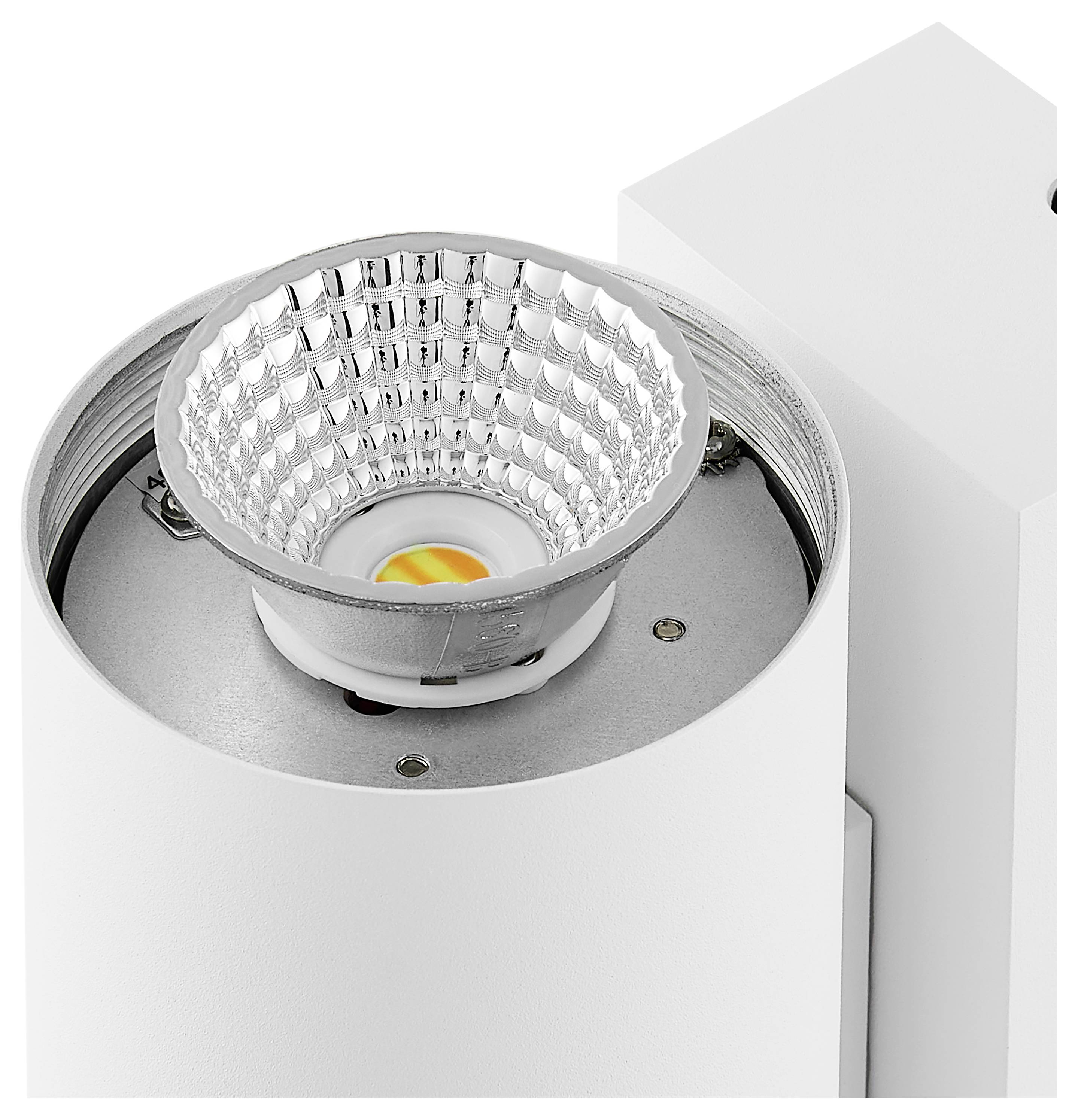 Nahaufnahme einer weißen LED-Spotlicht-Leuchte mit reflektierendem Kegel und sichtbarer orangefarbener Lichtquelle im Inneren.