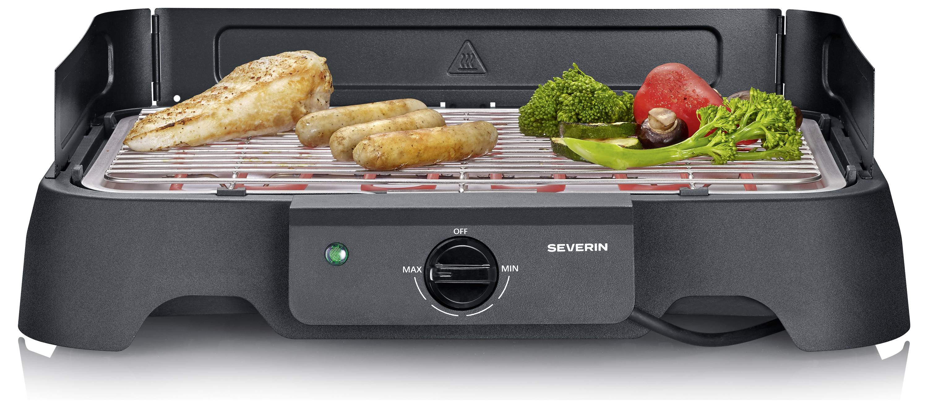 Elektrischer Tischgrill mit Hähnchenbrust, Würstchen, Brokkoli, Pilzen und roten Gemüsesorten auf einem gerillten Rost mit sichtbarem Temperaturregelknopf.