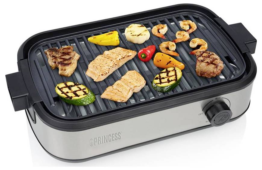 Elektrischer Tischgrill mit verschiedenen Lebensmitteln auf der gerillten Oberfläche, darunter Fleisch, Fisch, Garnelen, Gemüse und Ananas.