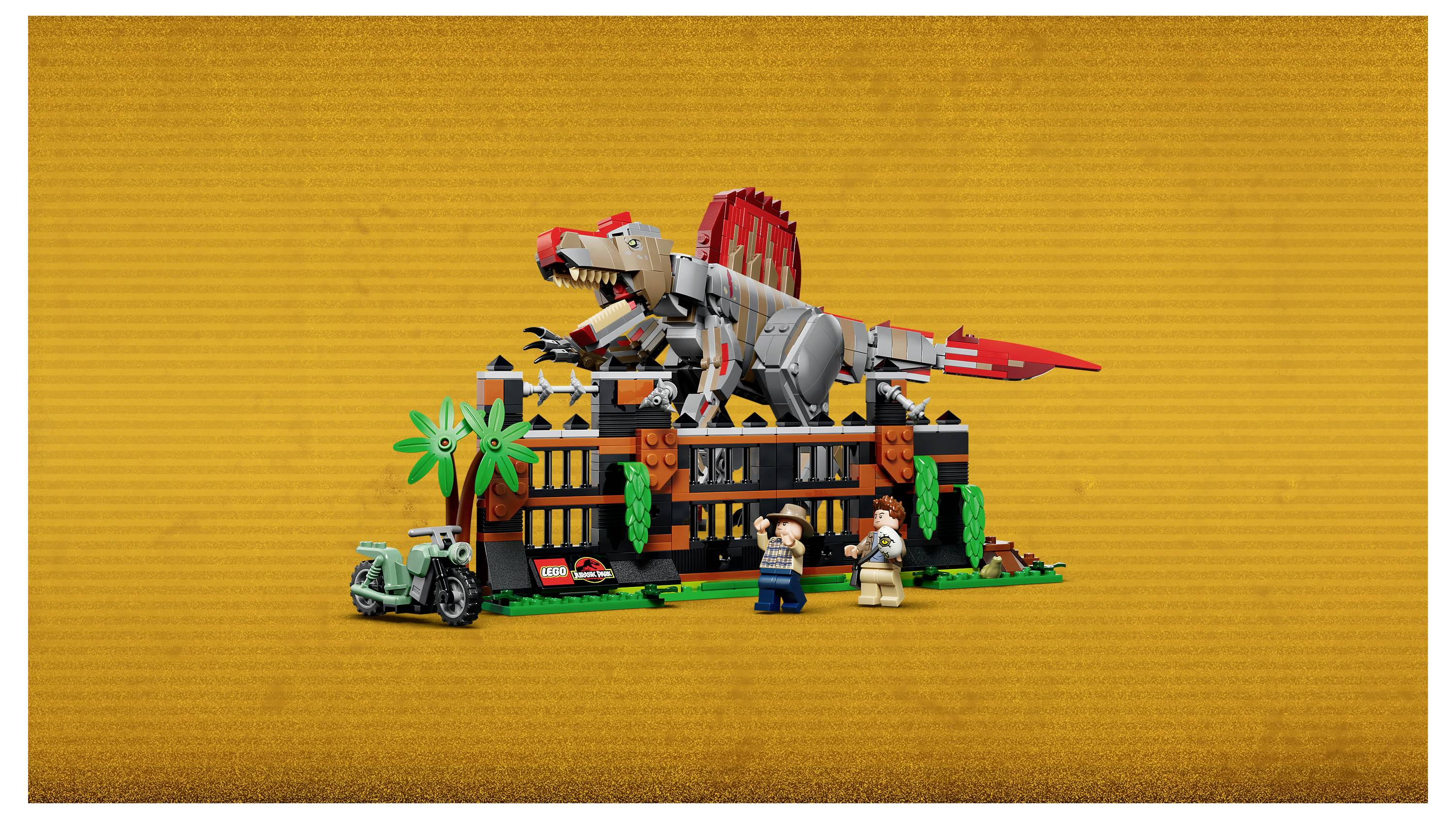 Eine LEGO-artige Szene mit einer Dinosaurier-Ausstellung mit einem großen rot-grauen Dinosaurier auf einem Gebäude, Palmen und zwei Minifiguren davor.