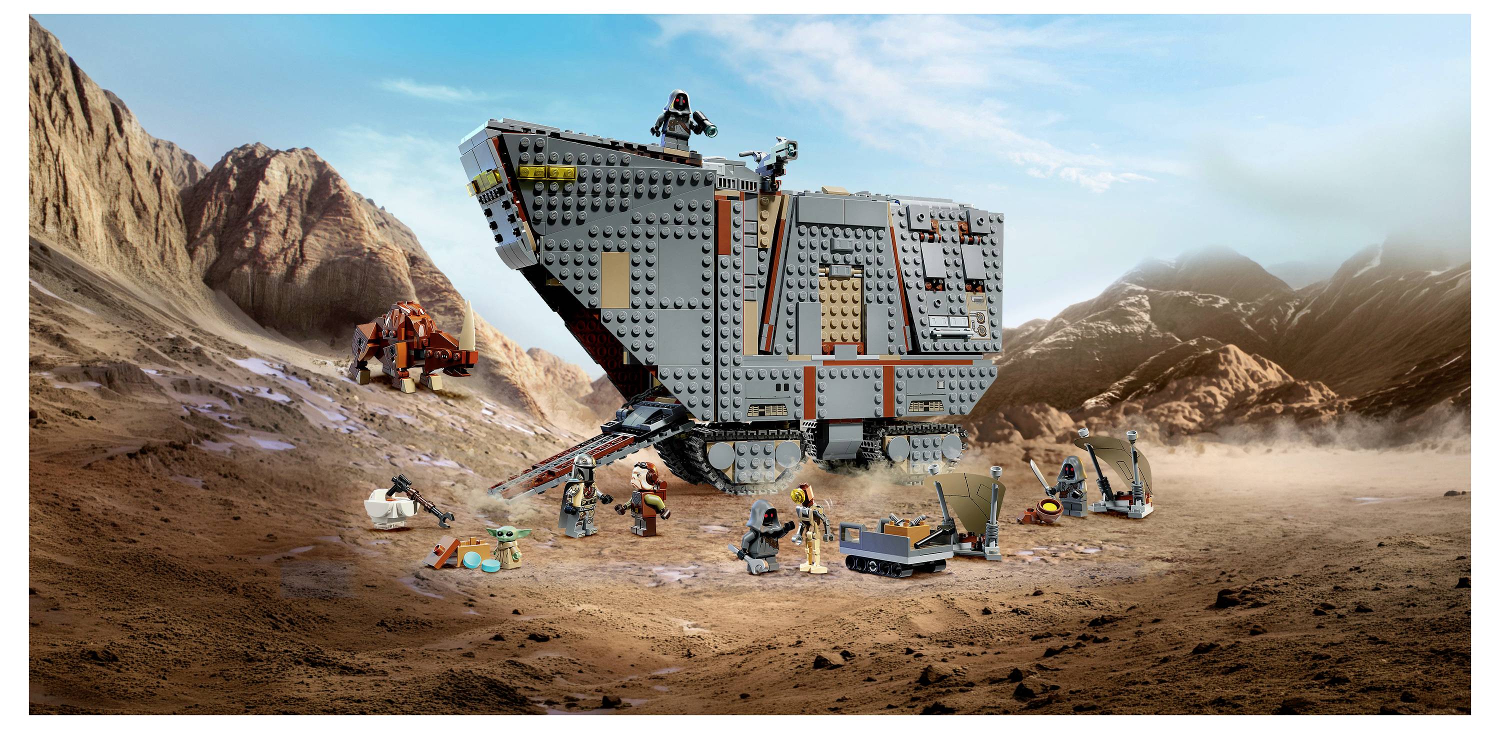 LEGO Star Wars Kampfszene mit einem großen graueren gepanzerten Fahrzeug in einer felsigen Wüste, umgeben von Minifiguren und kleinen Kampffahrzeugen inmitten von Staub und Explosionen.