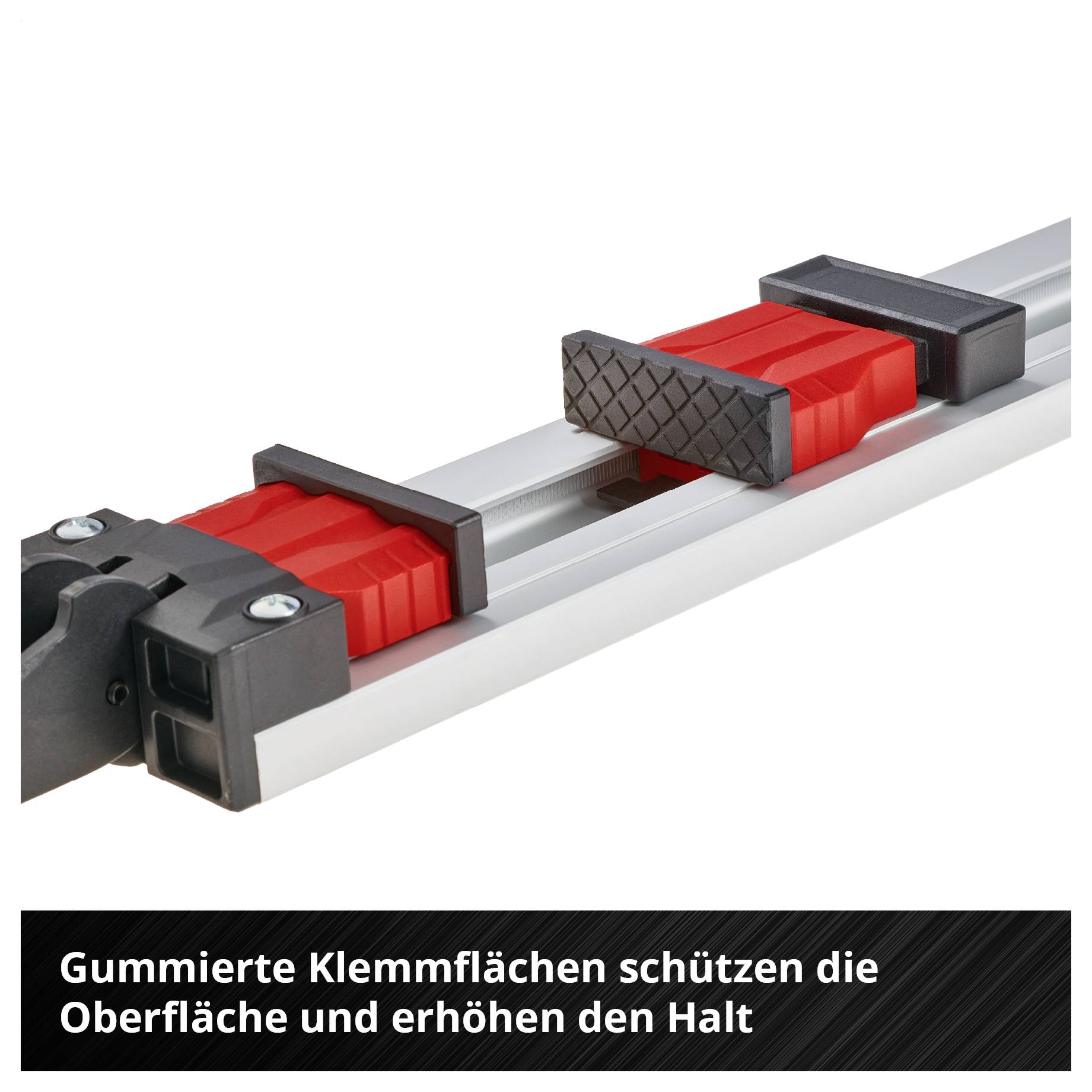Zwei rote Klemmblöcke auf einer Metallschiene mit gummierten Kontaktflächen; Text: 'Gummierte Klemmflächen schützen die Oberfläche und erhöhen den Halt'.