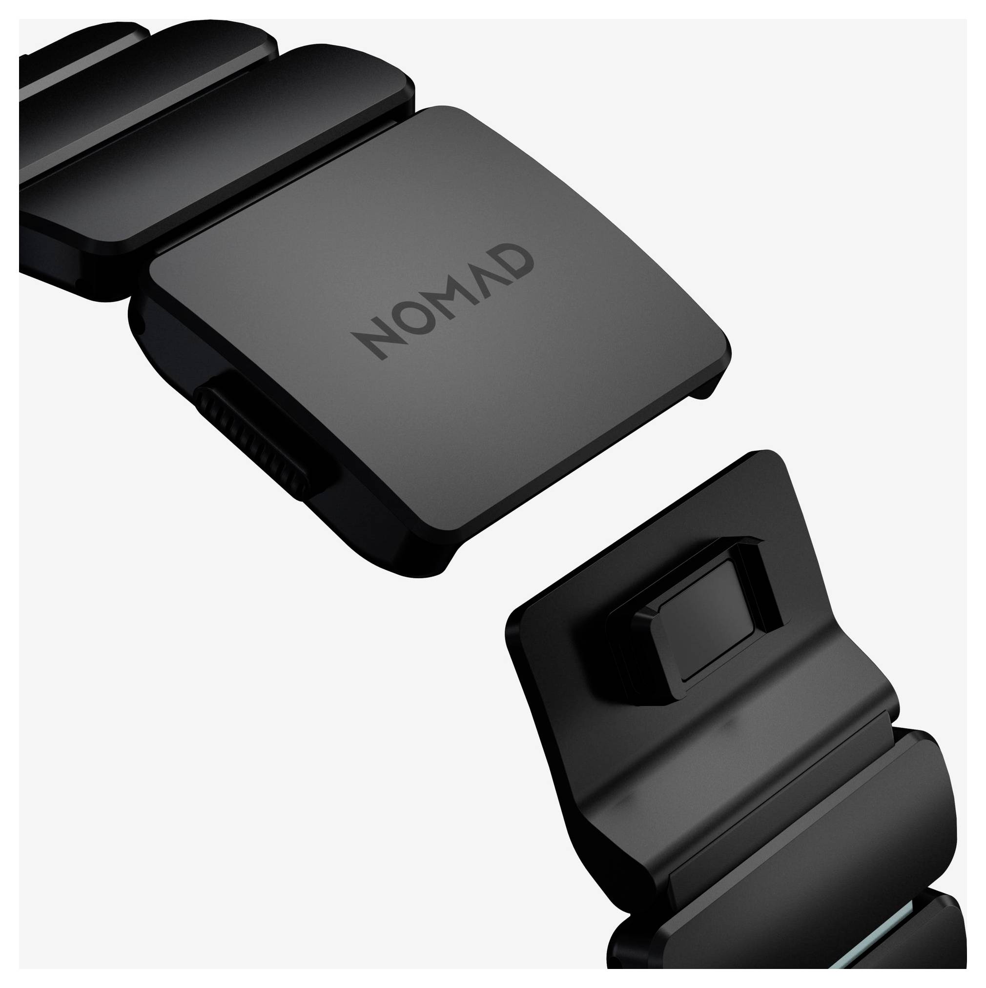 Schwarzes NOMAD Uhrenarmband mit zwei magnetischen Verschlussteilen, separat auf weißem Hintergrund dargestellt.