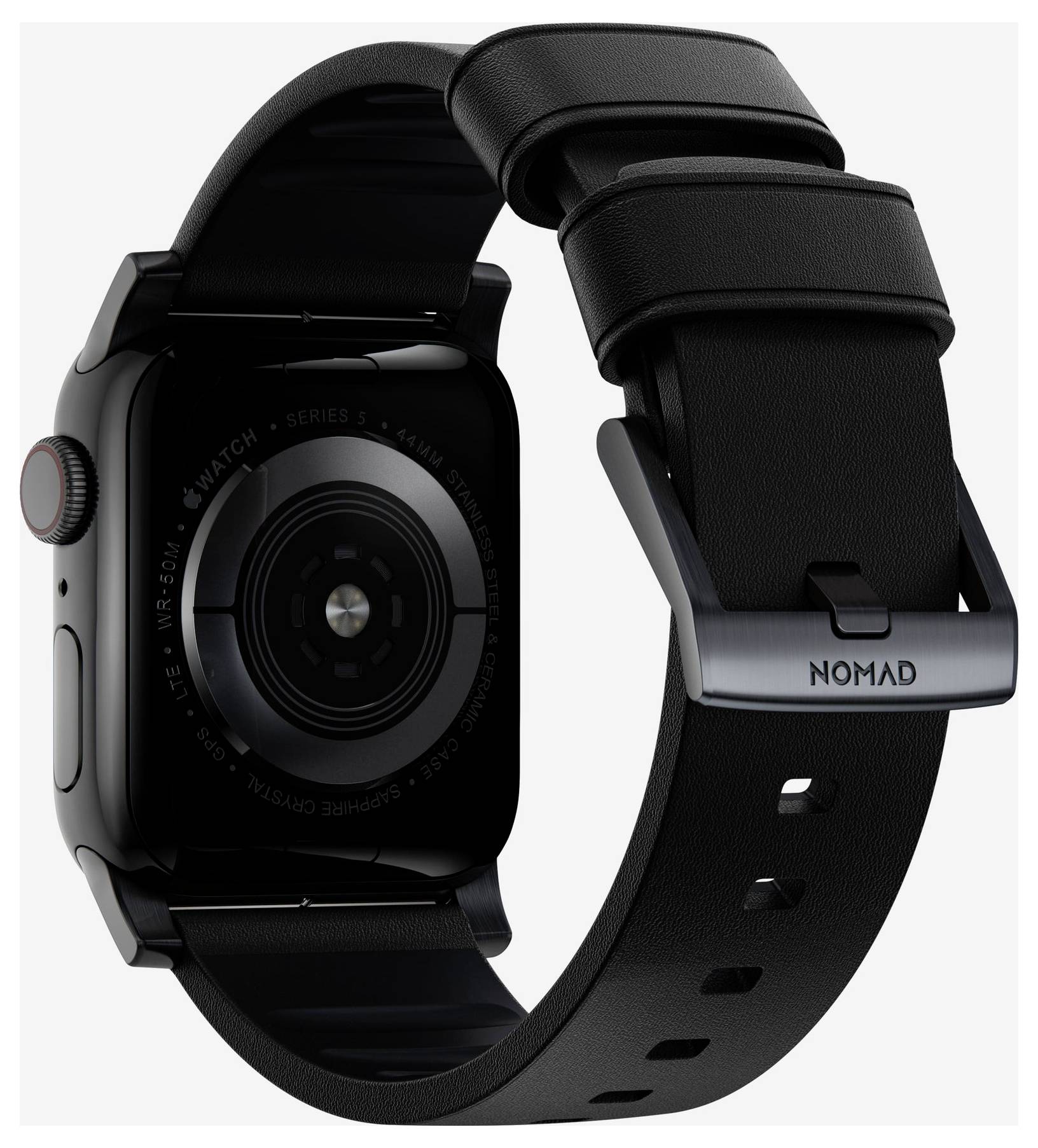 Schwarze Apple Watch von hinten mit schwarzem Nomad-Armband und Metallschnalle, zeigt den kreisförmigen Sensor und die seitliche Krone.