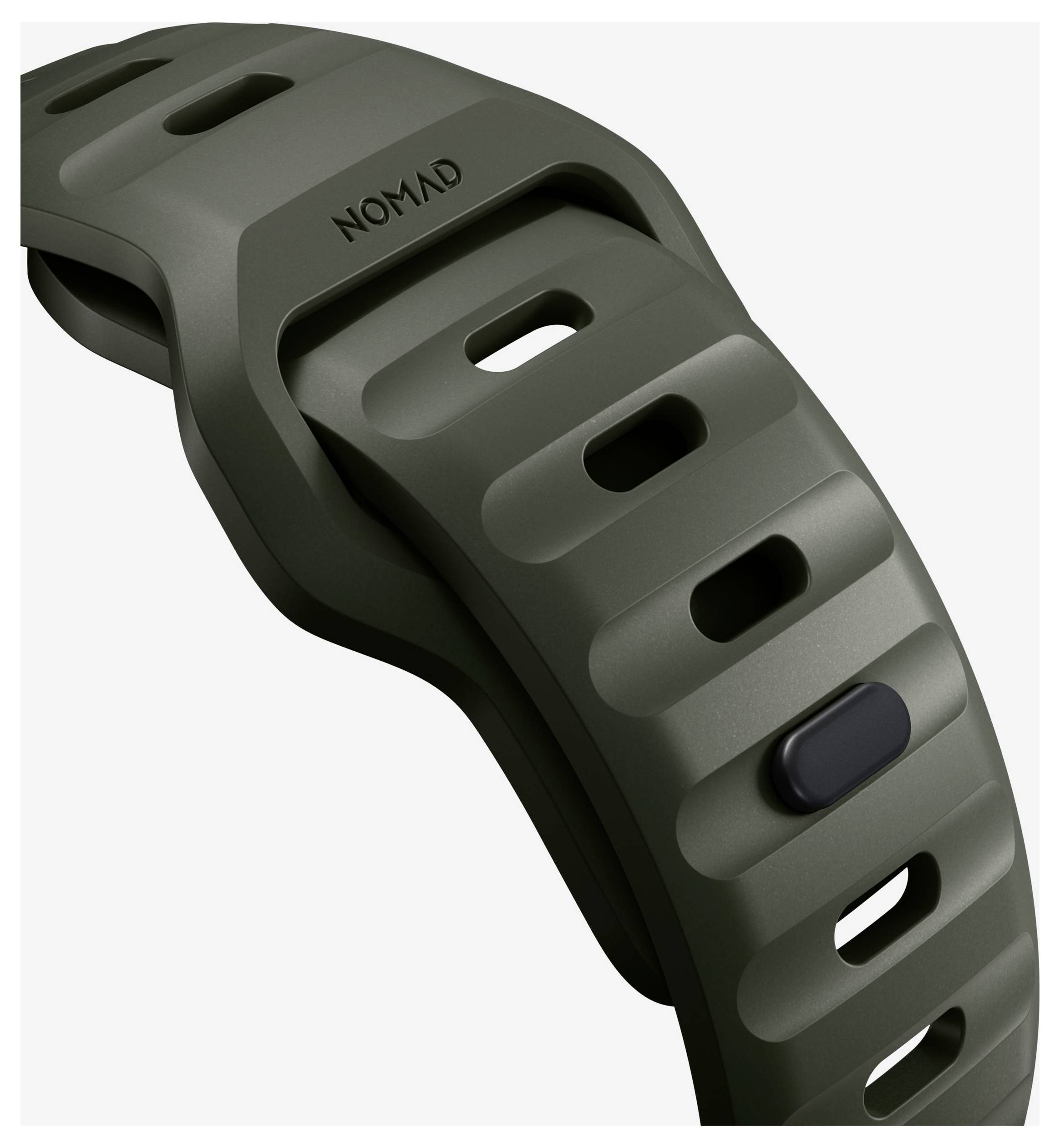 Nahaufnahme eines dunkelgrünen Nomad-Uhrenarmbandes mit geformten Schlitzen und einer Schnallenseite auf hellem Hintergrund.