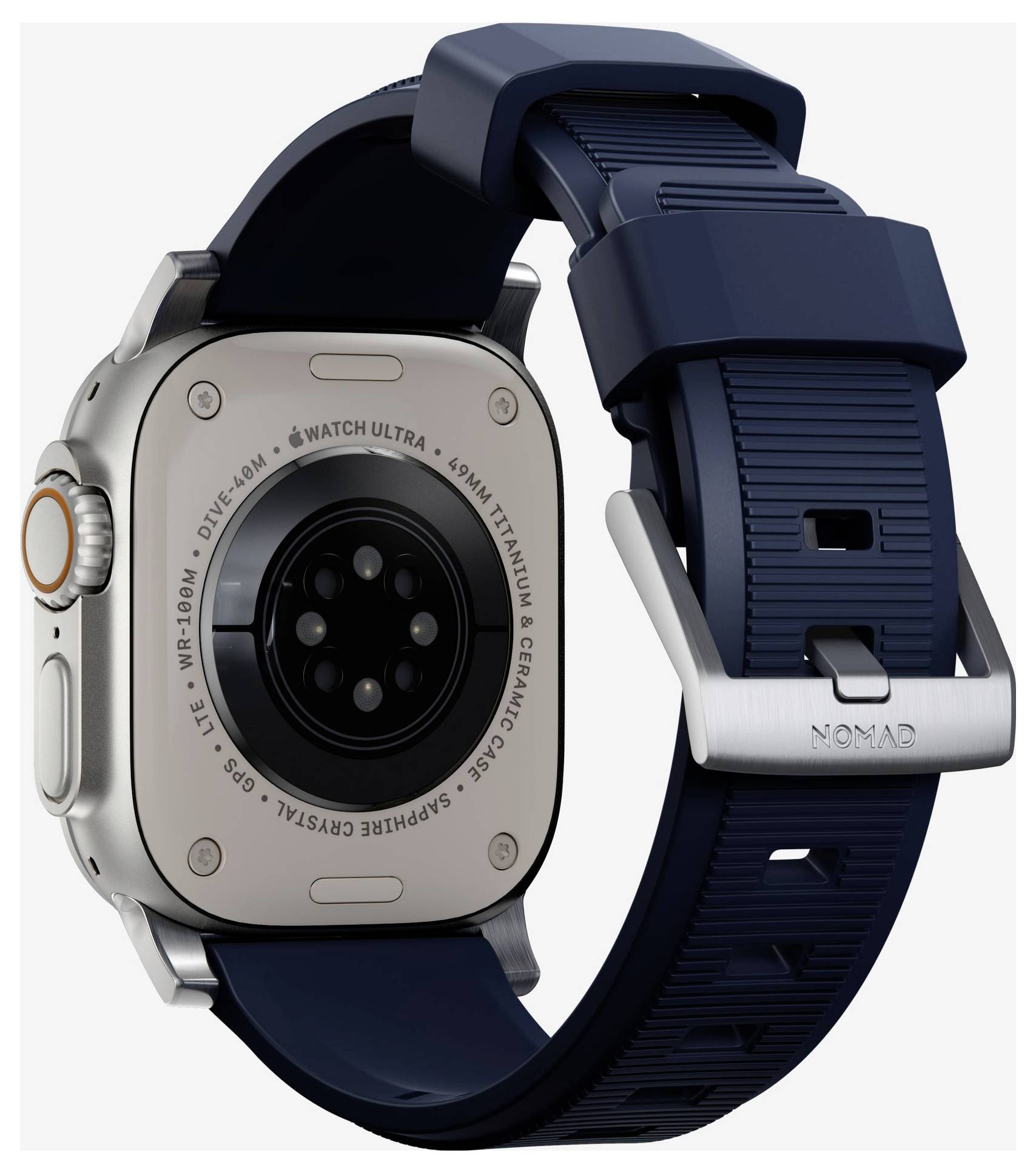 Apple Watch Ultra mit einem dunkelblauen Nomad-Armband, von hinten gezeigt, um das Uhrengehäuse, den Sensor und die Armbandanbringung hervorzuheben.