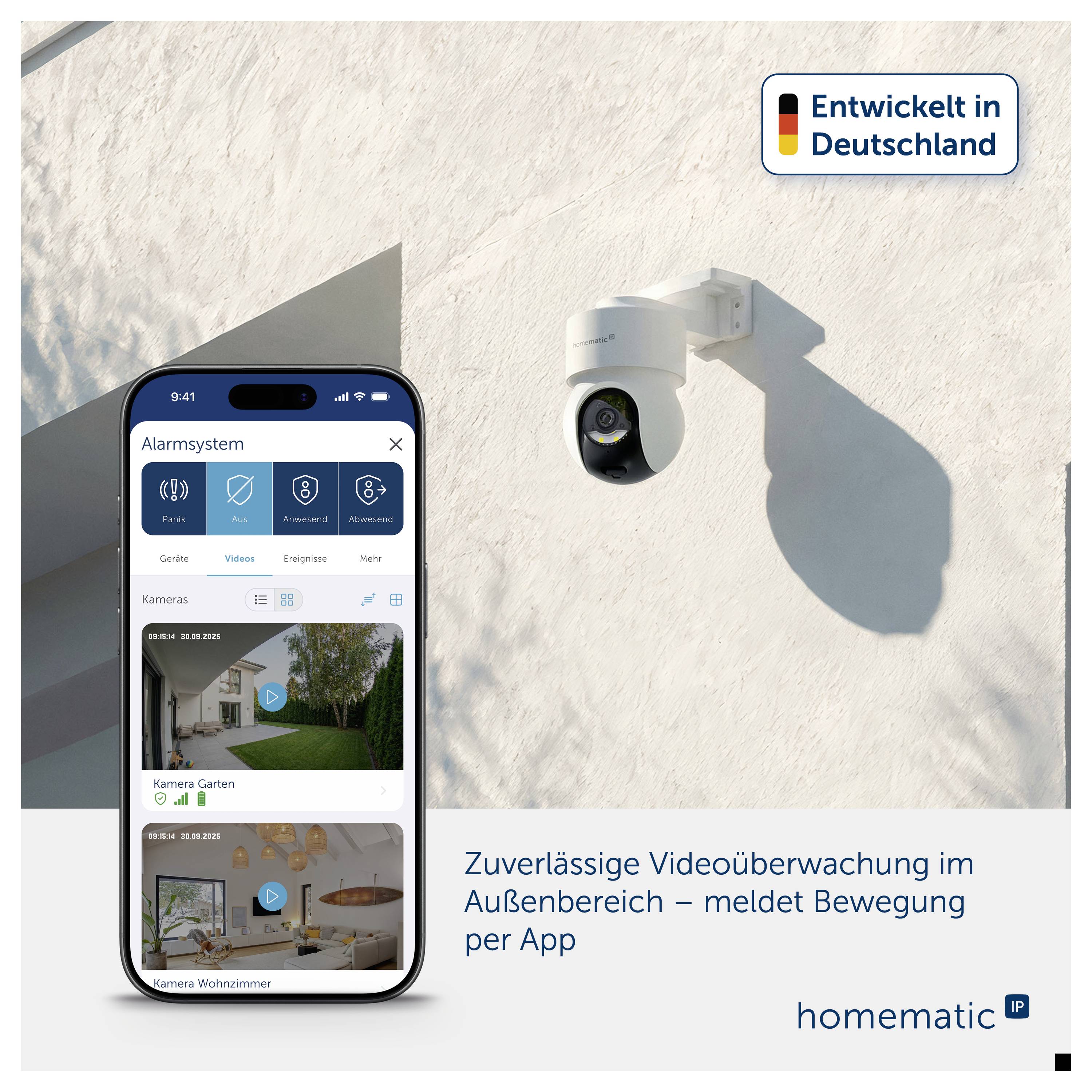 Smartphone mit Alarm-App steuert Außenkamera an weißer Wand; Werbetext: 'Zuverlässige Videoüberwachung im Außenbereich – meldet Bewegung per App'.