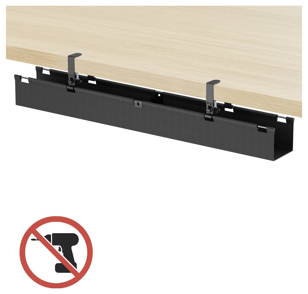 Schwarze Kabelführungsschale unter dem Schreibtisch, montiert auf einem Holzschreibtisch, mit einem Symbol für Bohrwarnhinweis darunter.