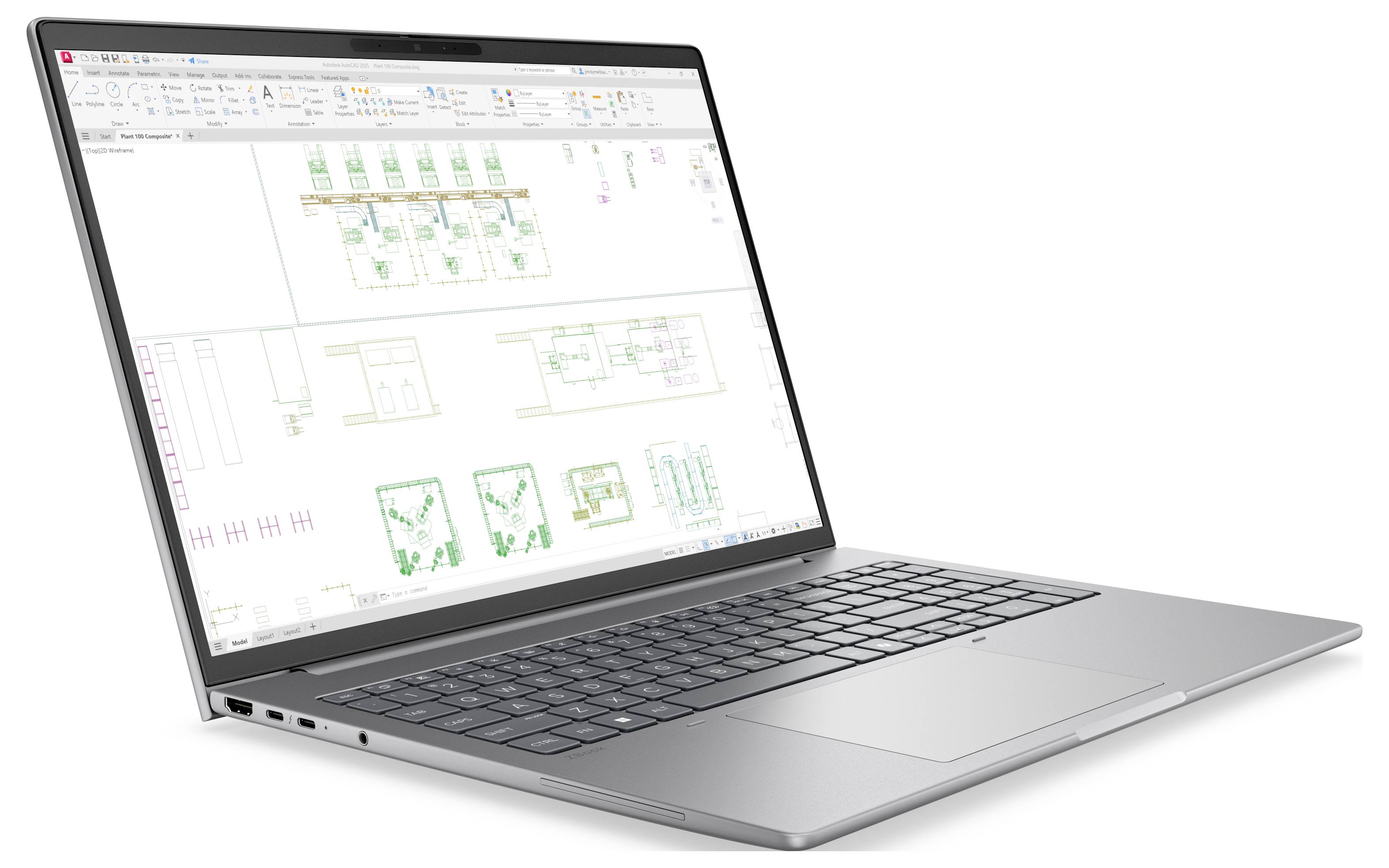 Silberner Laptop, auf dem ein CAD-/Konstruktionsprogramm mit technischen Grundrissdiagrammen auf einem weißen Bildschirm angezeigt wird