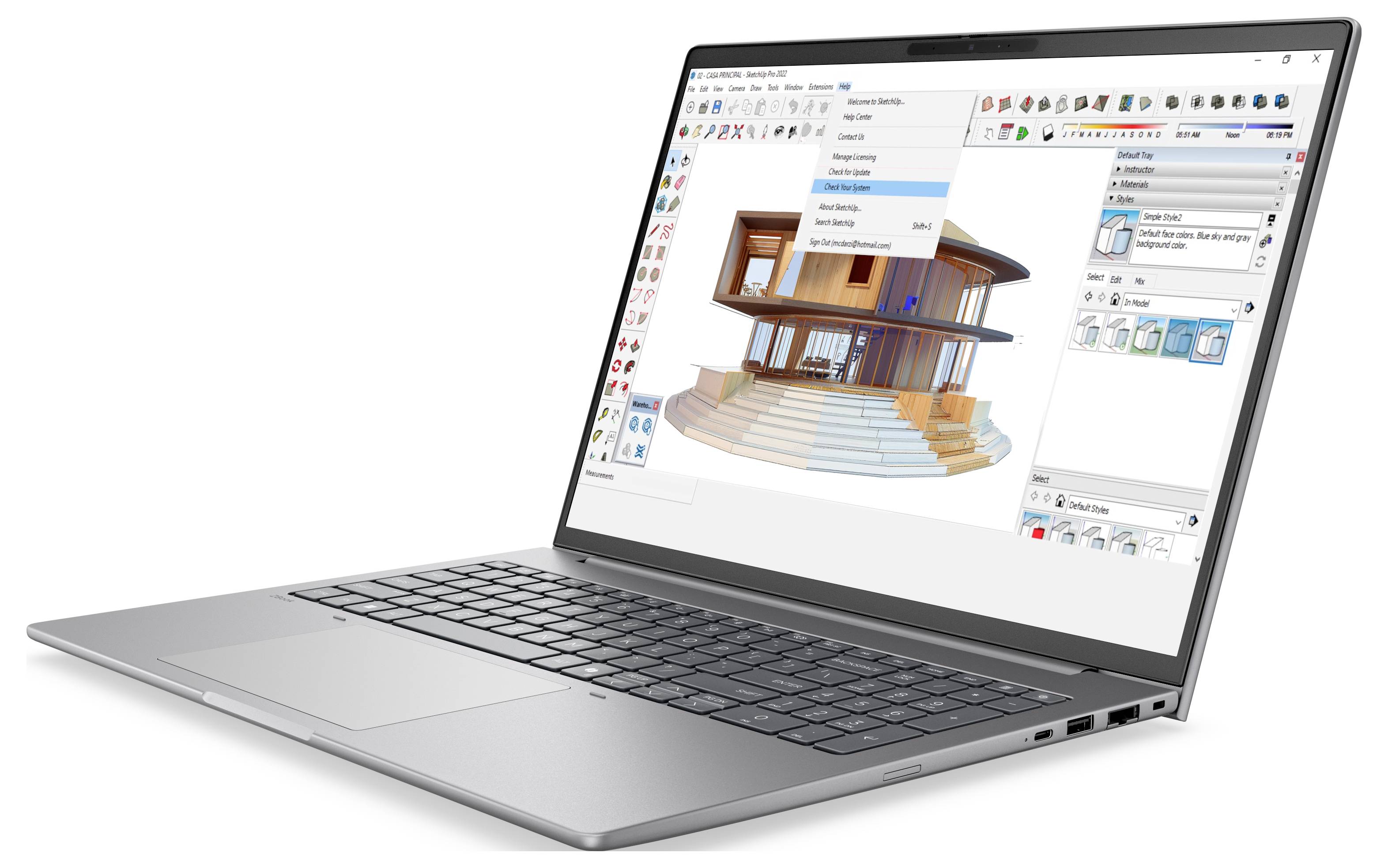 Laptop zeigt 3D-Architektur-Designsoftware mit modernem Hausmodell und sichtbaren Bearbeitungswerkzeugleisten auf dem Bildschirm an.
