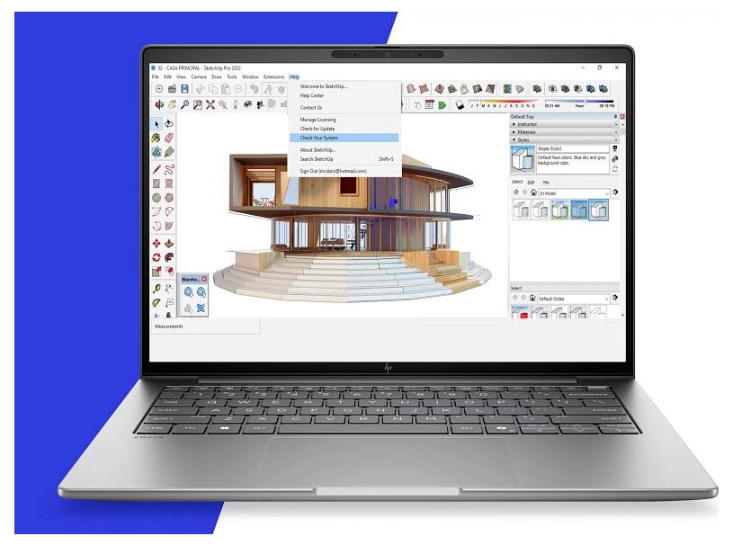 Laptop zeigt 3D-Architekturmodellierungssoftware mit offenem modernem Hausdesign auf dem Bildschirm und Symbolleisten rund um den Arbeitsbereich.