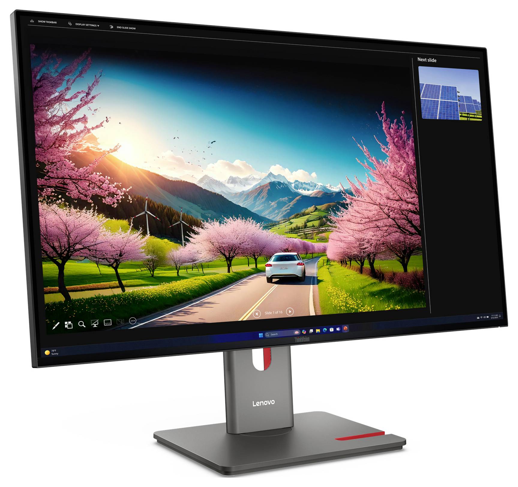 Lenovo-Monitor zeigt ein lebendiges Landschafts-Hintergrundbild eines Autos, das auf einer Straße durch rosa blühende Bäume in Richtung Berge bei Sonnenuntergang fährt.