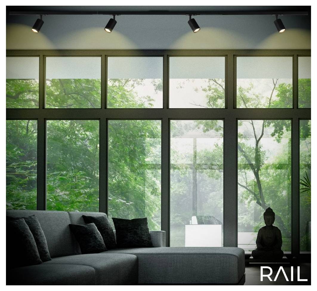 Modernes Wohnzimmer mit einem grauen Ecksofa und einer Buddha-Statue vor bodentiefen Fenstern mit Blick auf üppig grüne Bäume und nebligem Licht.