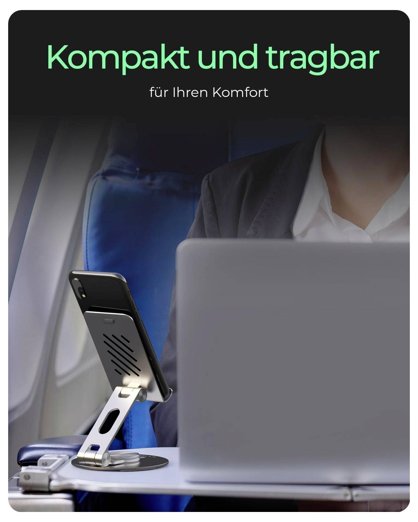 # Übersetzung:Person, die einen Laptop in einem Flugzeug benutzt, mit einem Telefon auf einem Ständer; Der deutsche Text lautet „Kompakt und tragbar