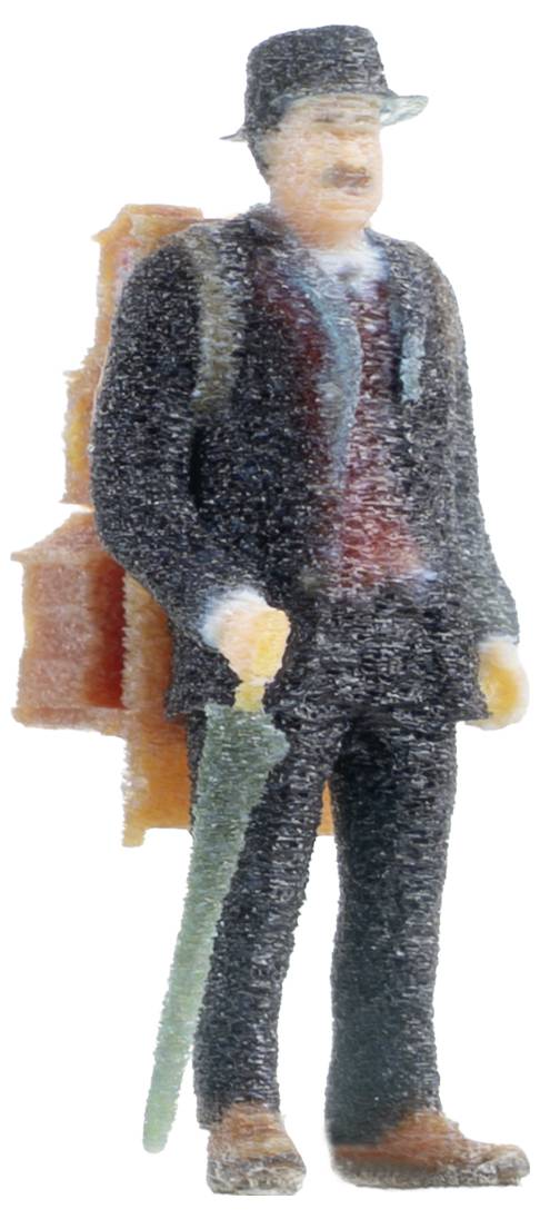 Miniaturefigur eines Mannes in Anzug und Hut, der einen grünen Schirm hält, mit einer braunen Tasche auf dem Rücken.