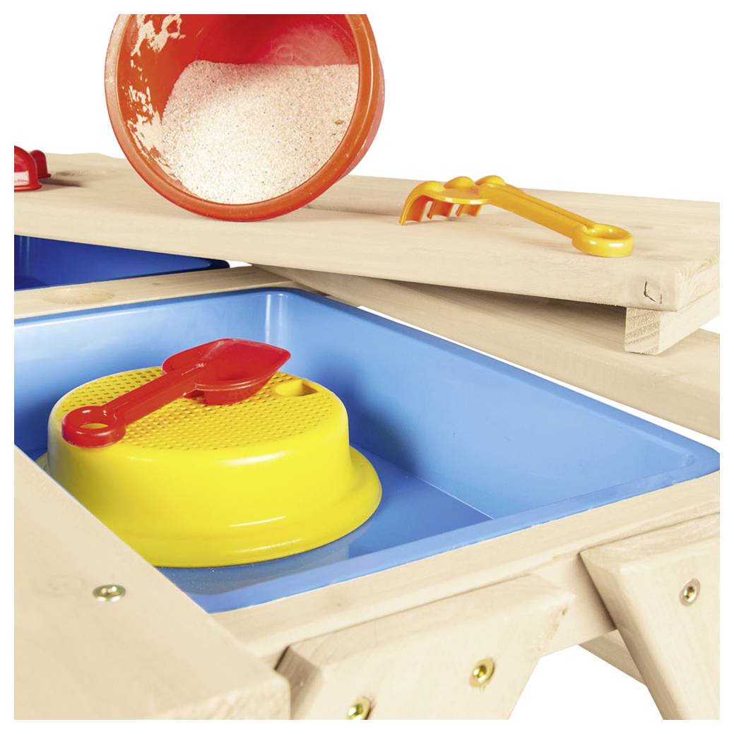 Nahaufnahme einer Sinnesspielstation für Kinder mit einem blauen Tablett, einer gelben strukturierten Plattform, einer roten Schaufel, einem orangefarbenen Eimer mit Körnern und einer gelben Zange.
