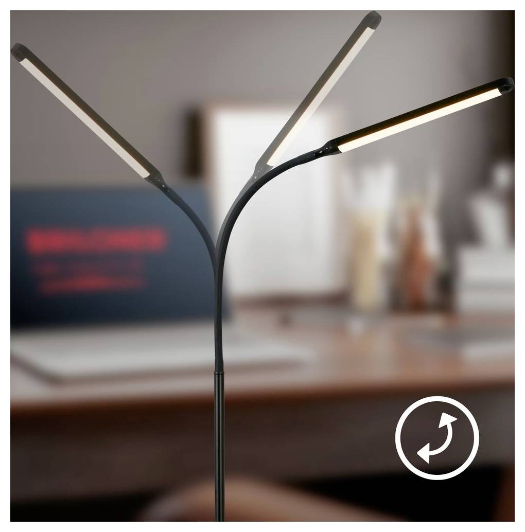 Dreiarmleuchtende LED-Schreibtischleuchte in einem unscharfen Büro- oder Heimarbeitsplatz, mit einem kreisförmigen Drehsymbol unten rechts.