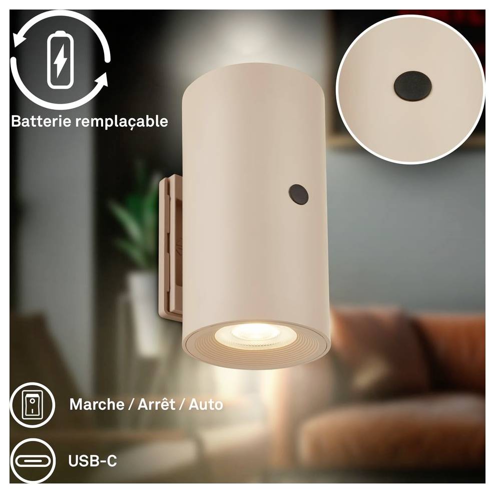 Beige wandmontierte zylindrische Leuchte mit sichtbarem Sensor, beschriftet mit 'Batterie austauschbar', 'Ein / Aus / Automatik' und 'USB-C'.
