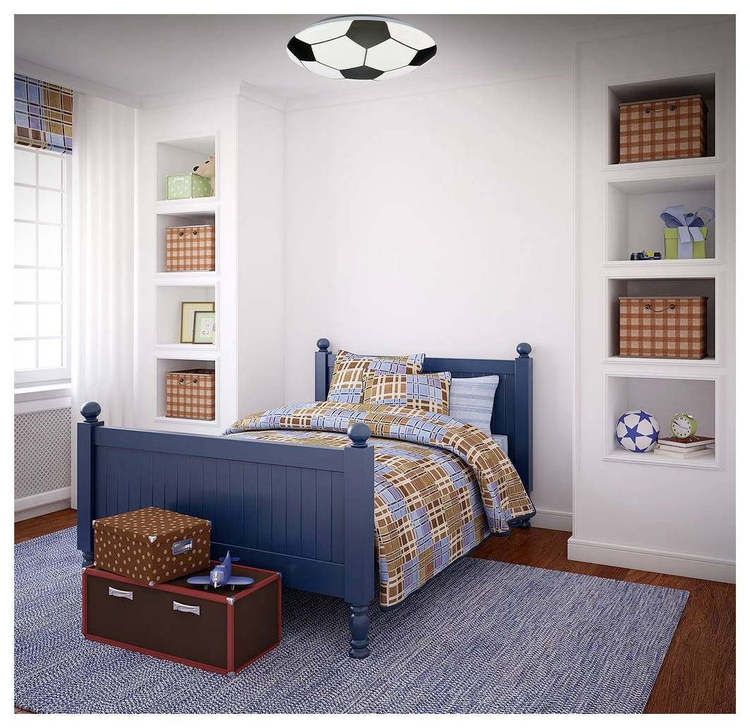 Blaues Doppelbett in einem hellen Schlafzimmer mit Fußball-Motiv-Dekor, eingebauten Regalen und einer kofferartigen Truhe am Fußende des Bettes.