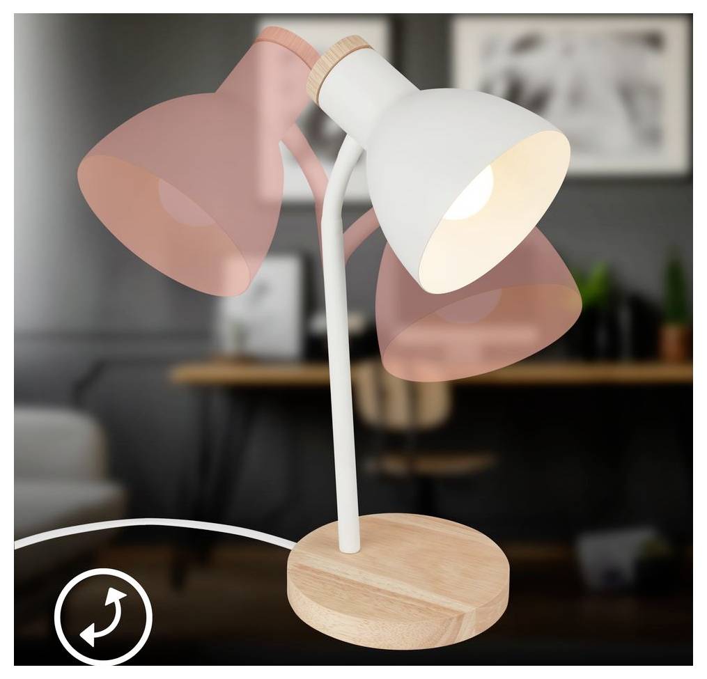 Eine weiße Schreibtischlampe mit drei rosa getönten Köpfen auf einer Holzbasis, gezeigt in einem unscharfen Rauminneren.